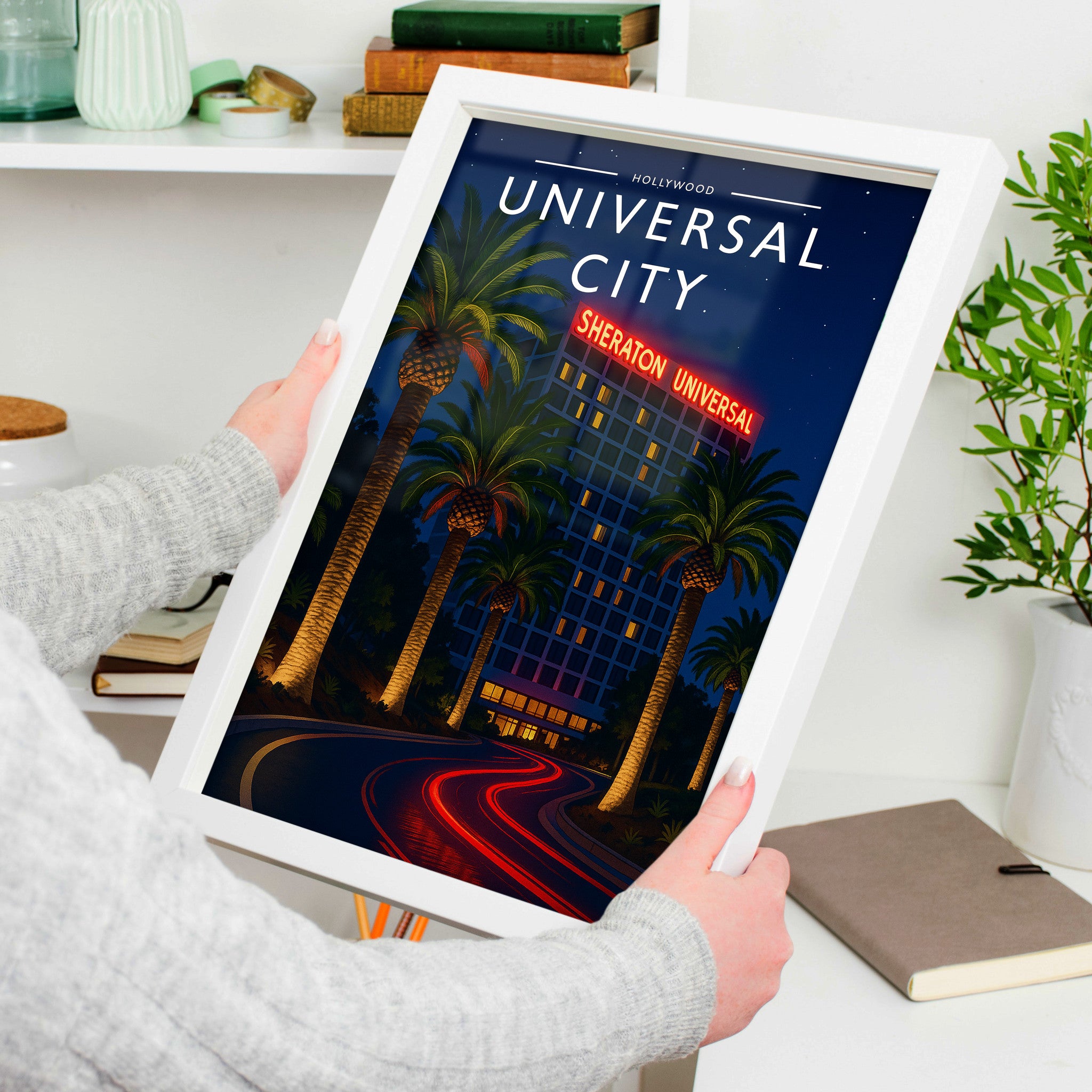 Universal City Travel Poster in a white frame, held to show scale