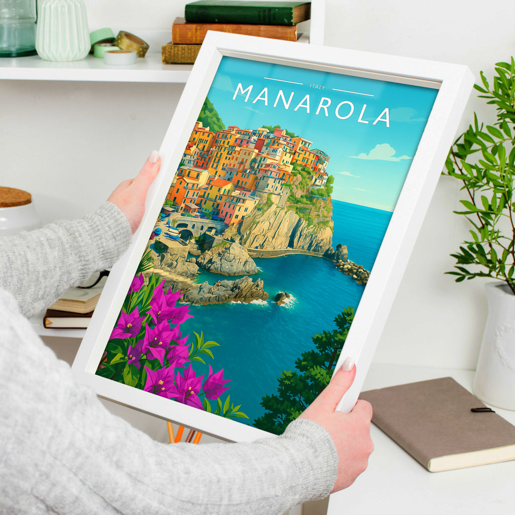 Manarola Travel Poster in a white frame, held to show scale