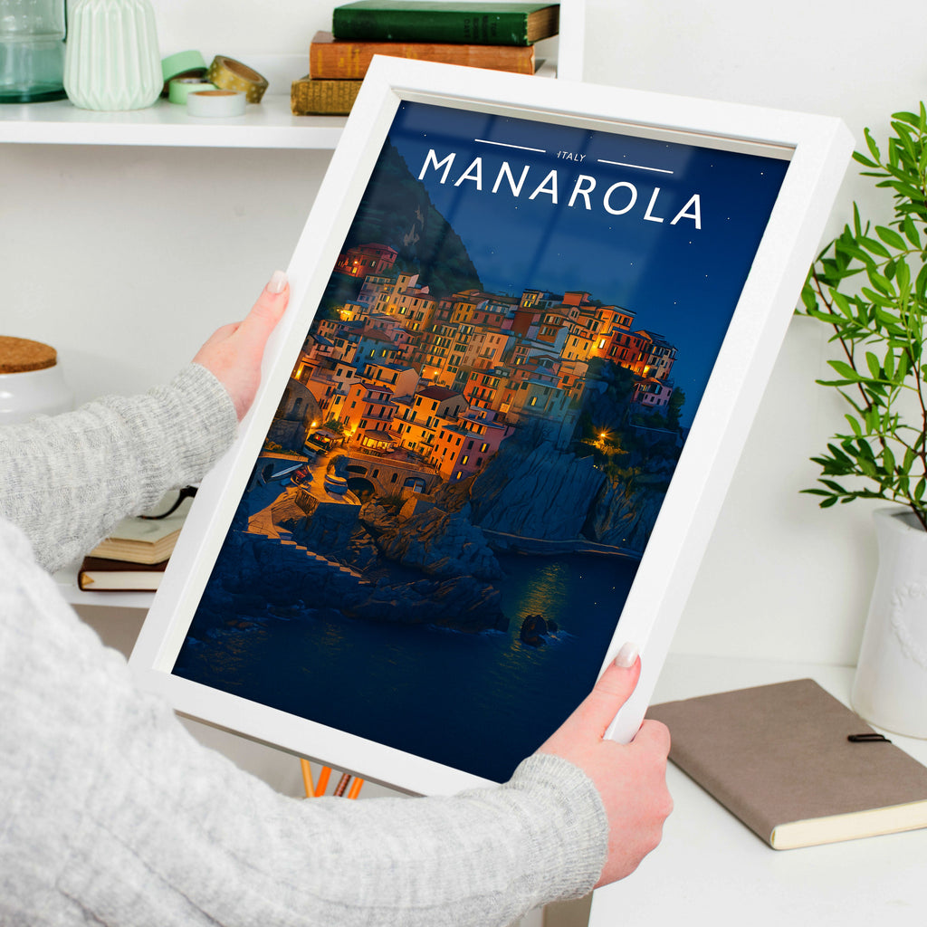 Manarola #2 Travel Poster in a white frame, held to show scale