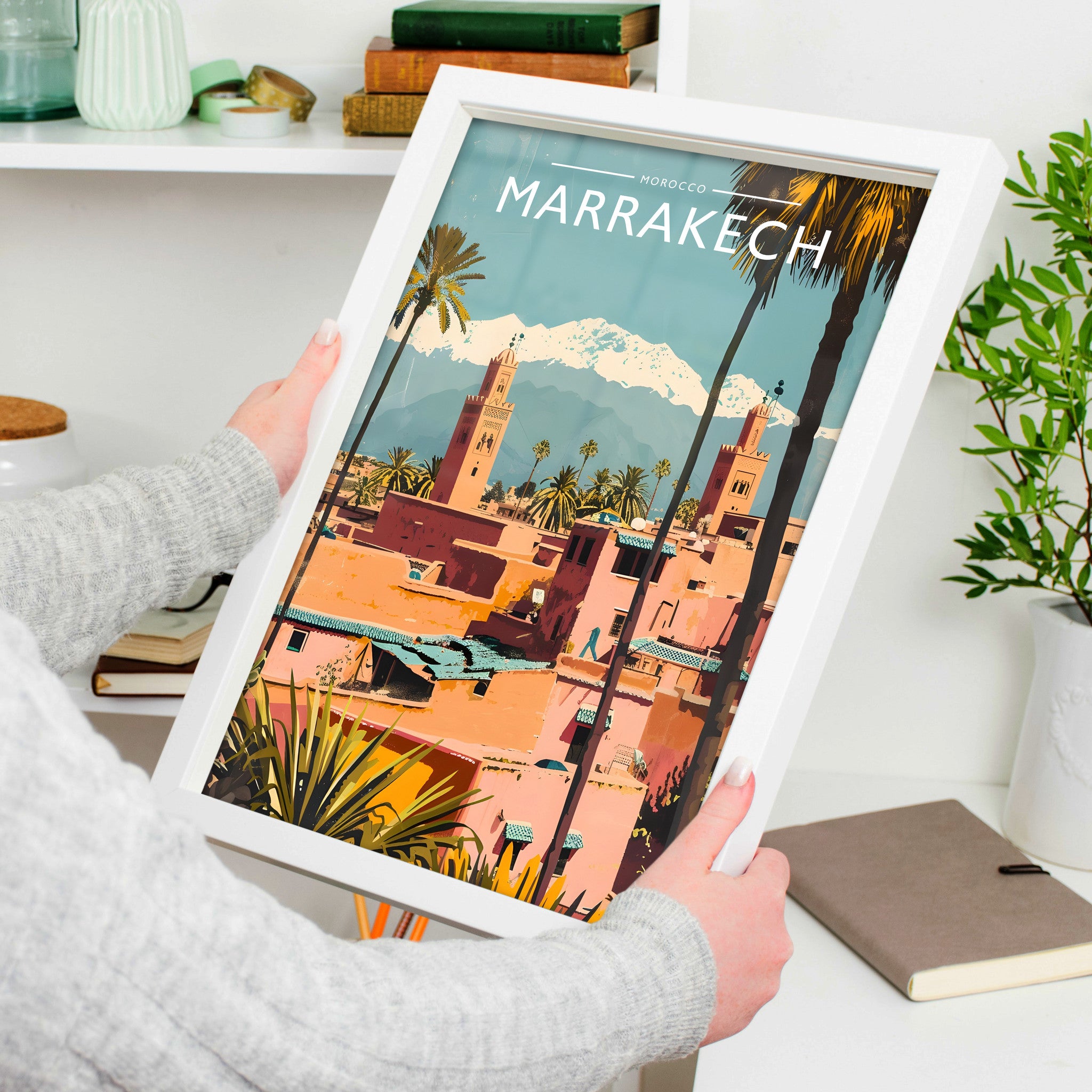 Marrakech Travel Poster in a white frame, held to show scale