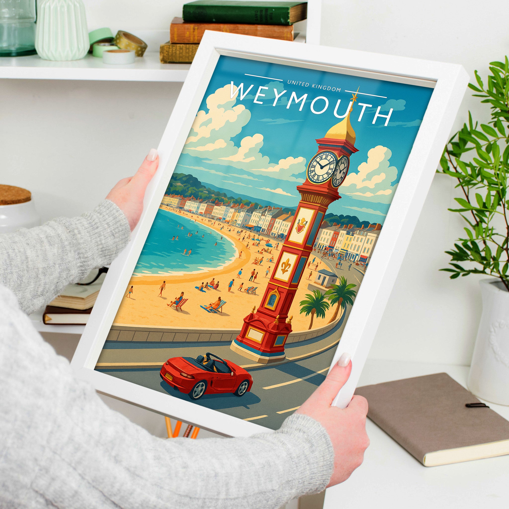 Weymouth Travel Poster in a white frame, held to show scale