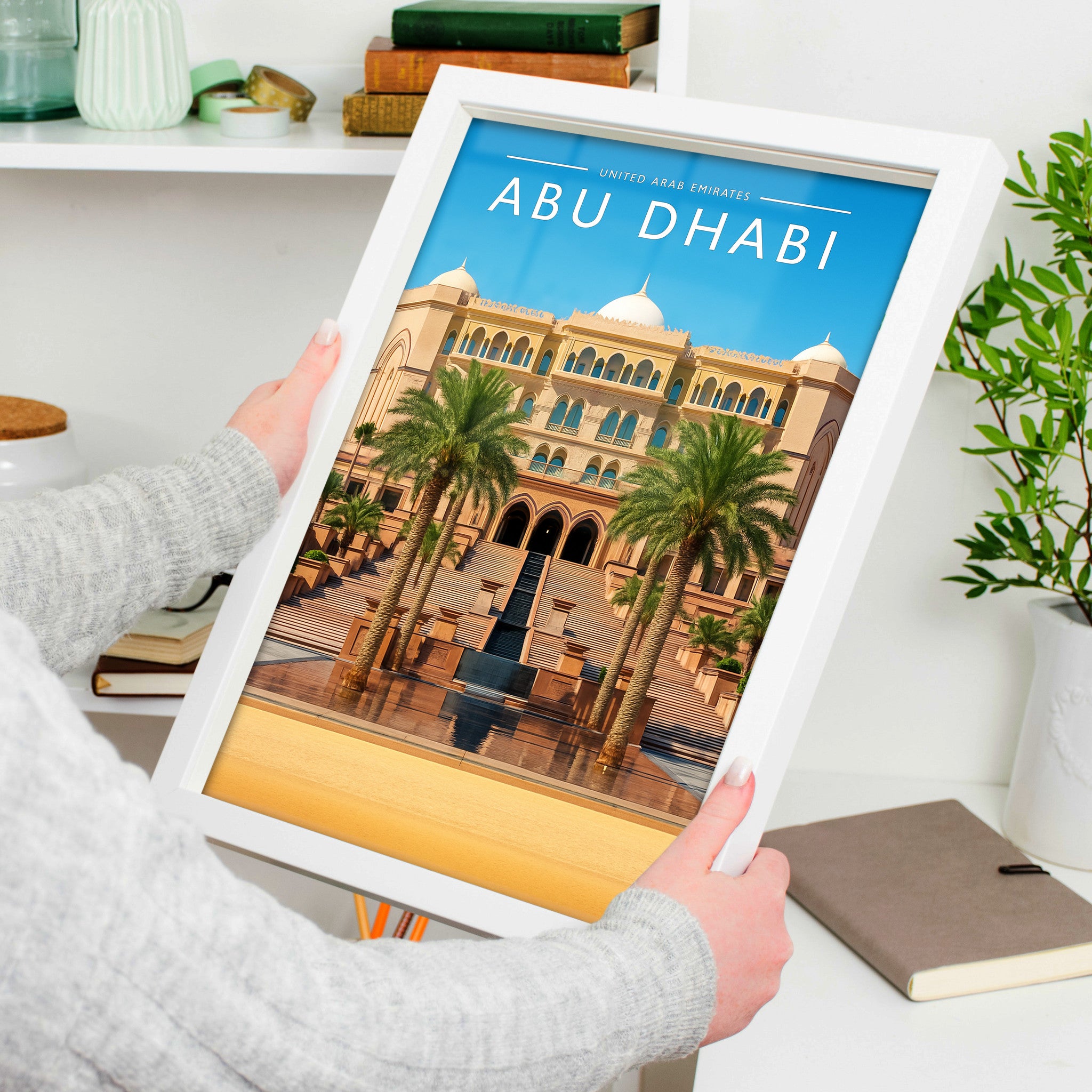 Abu Dhabi Travel Poster in a white frame, held to show scale