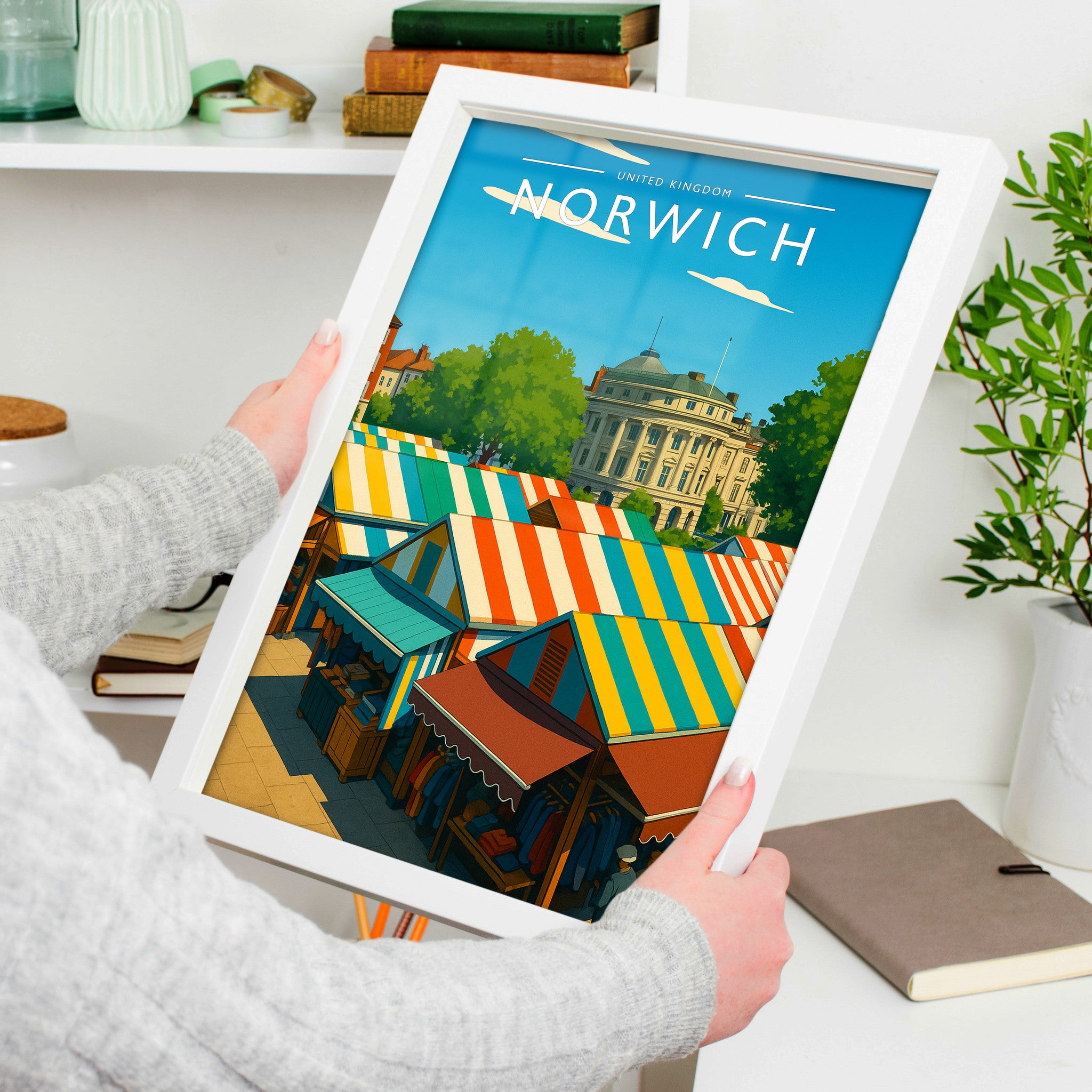 Norwich Travel Poster in a white frame, held to show scale