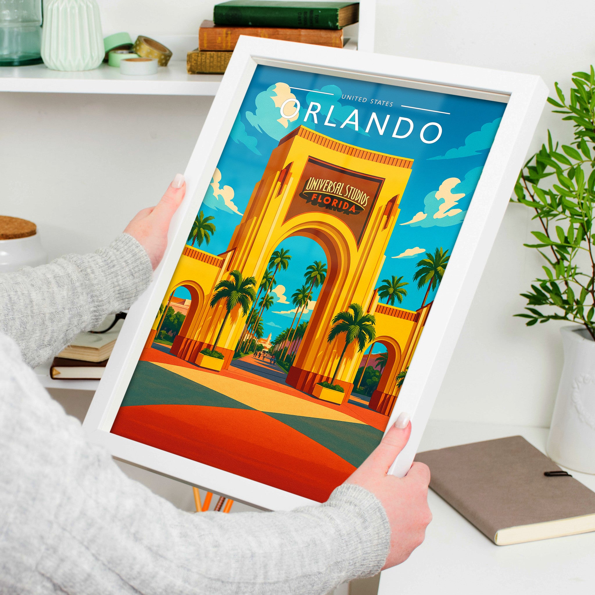 Orlando Travel Poster in a white frame, held to show scale