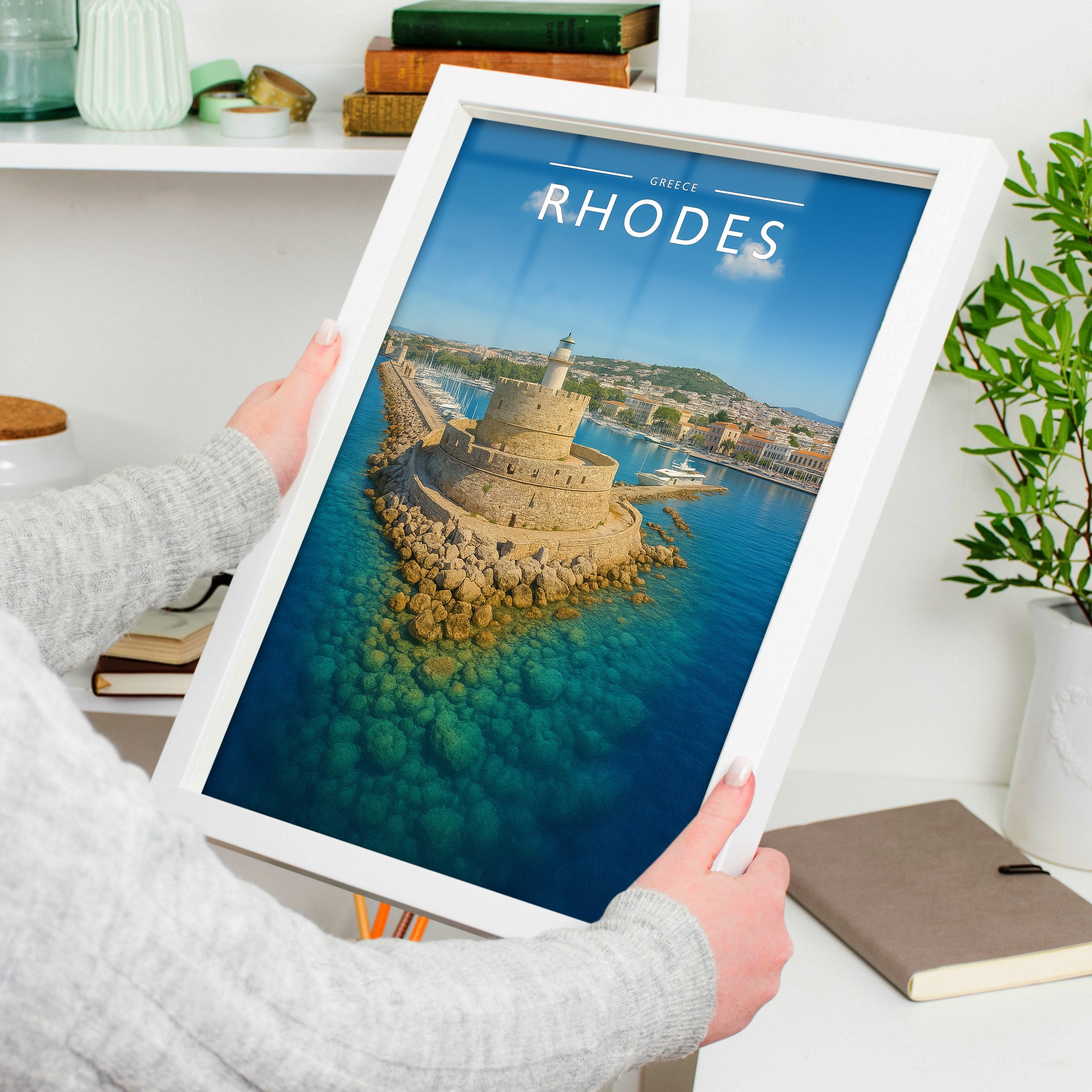 Rhodes Travel Poster in a white frame, held to show scale