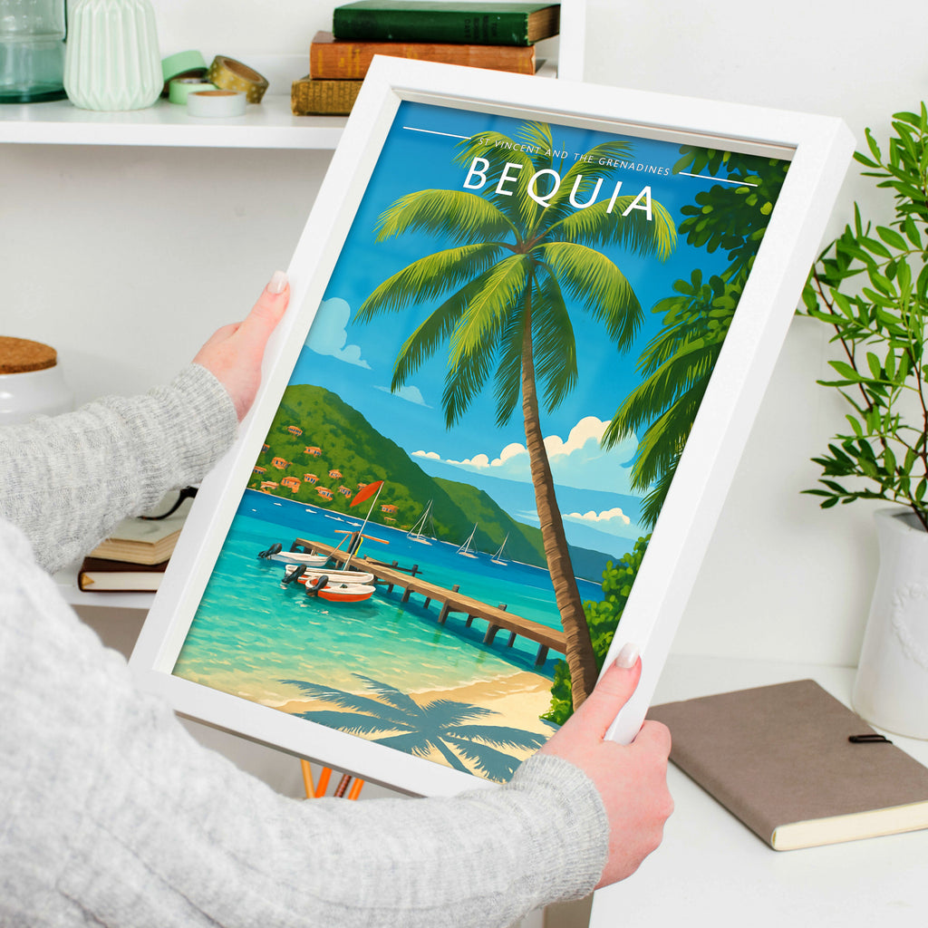 Bequia Travel Poster in a white frame, held to show scale