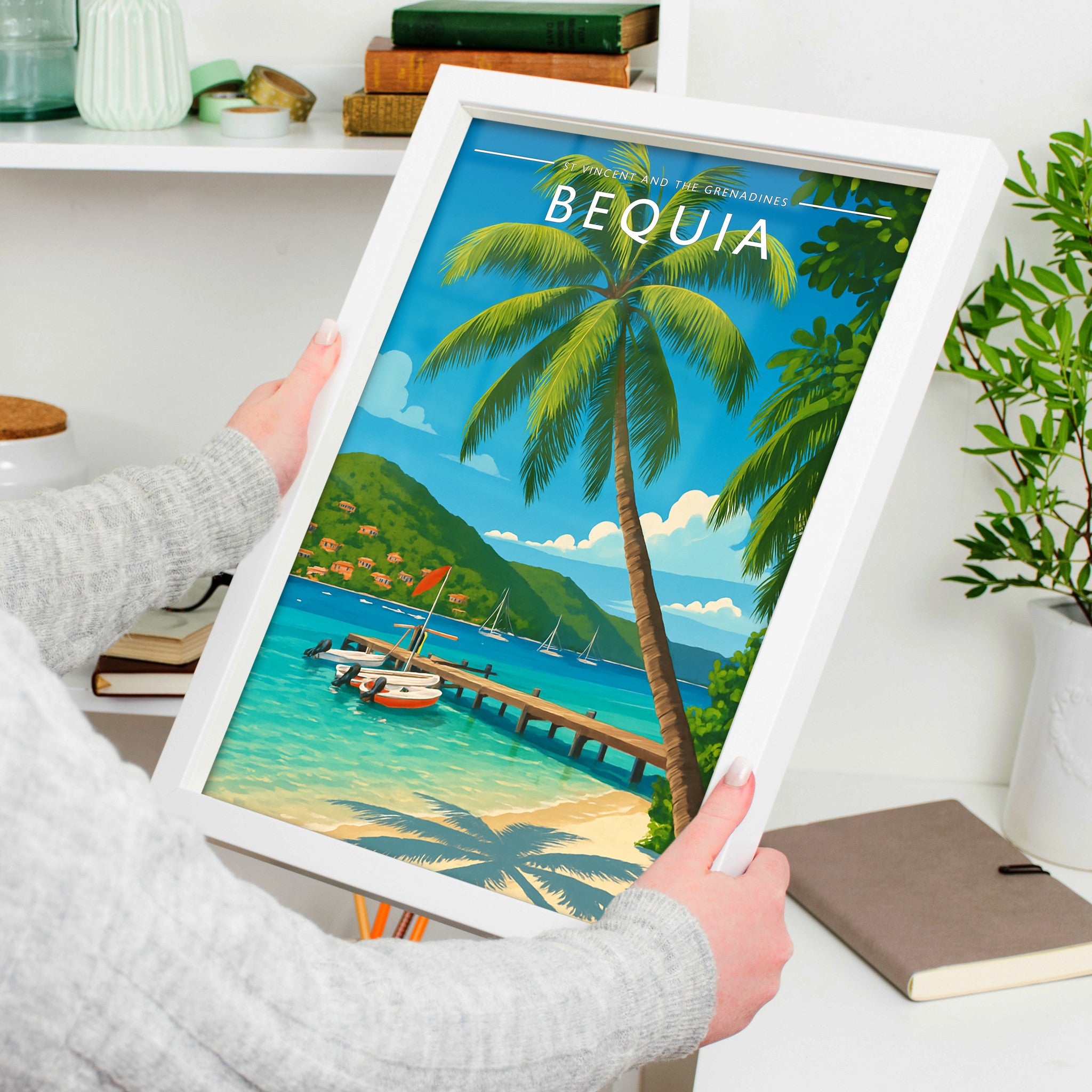 Bequia Travel Poster in a white frame, held to show scale