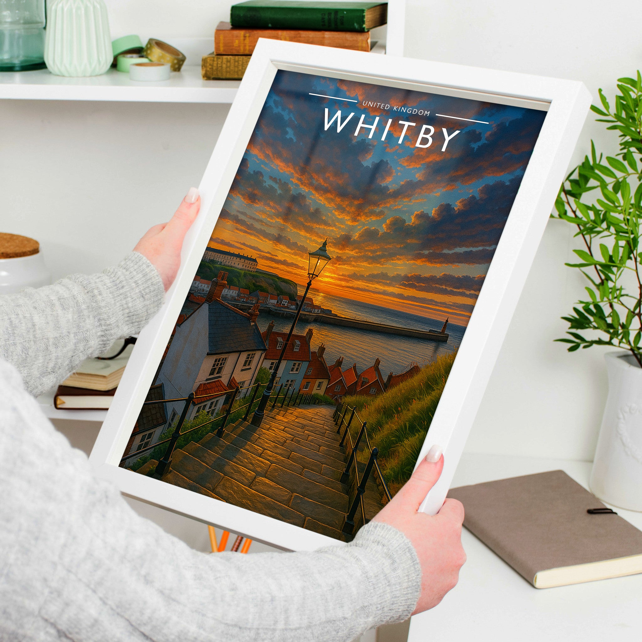 Whitby Travel Poster in a white frame, held to show scale