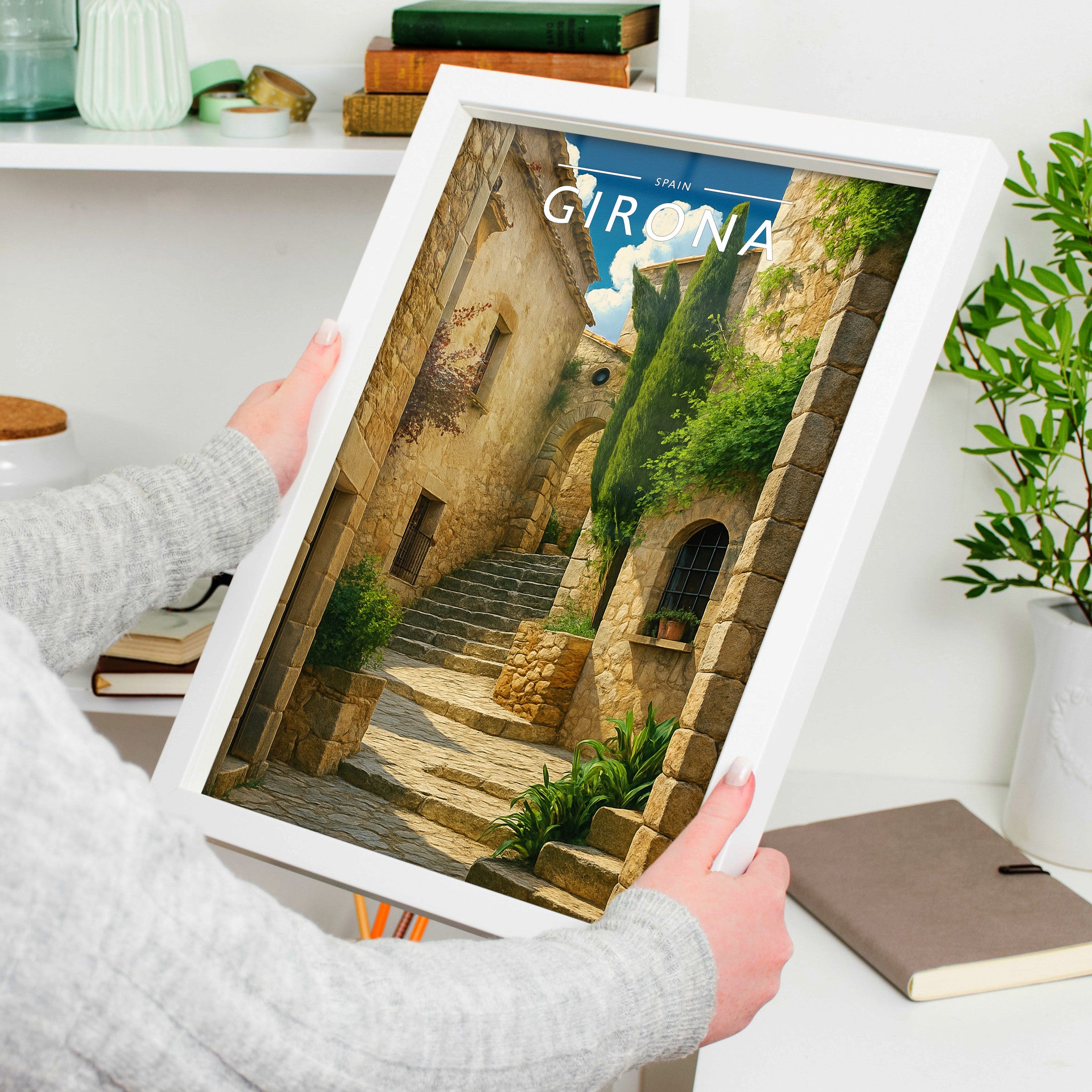 Girona Travel Poster in a white frame, held to show scale