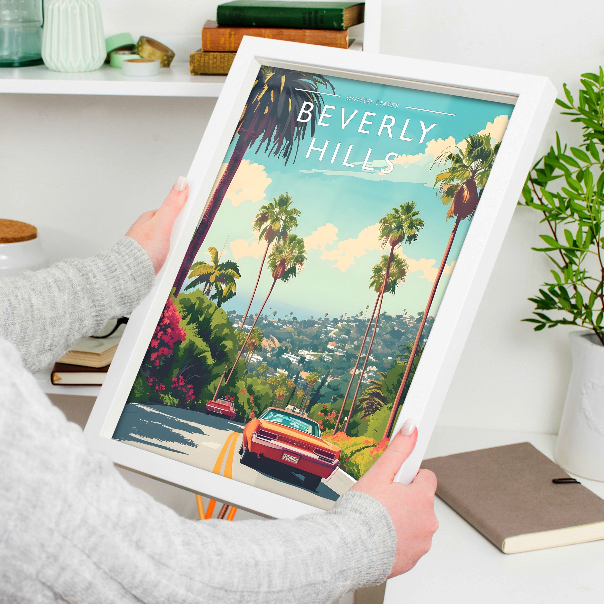 Beverly Hills Travel Poster in a white frame, held to show scale