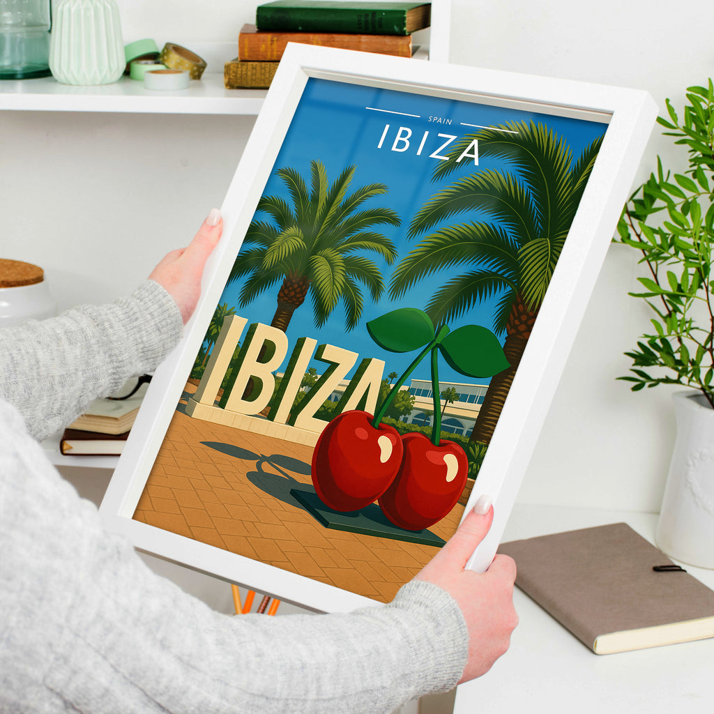 Ibiza #8 Travel Poster in a white frame, held to show scale