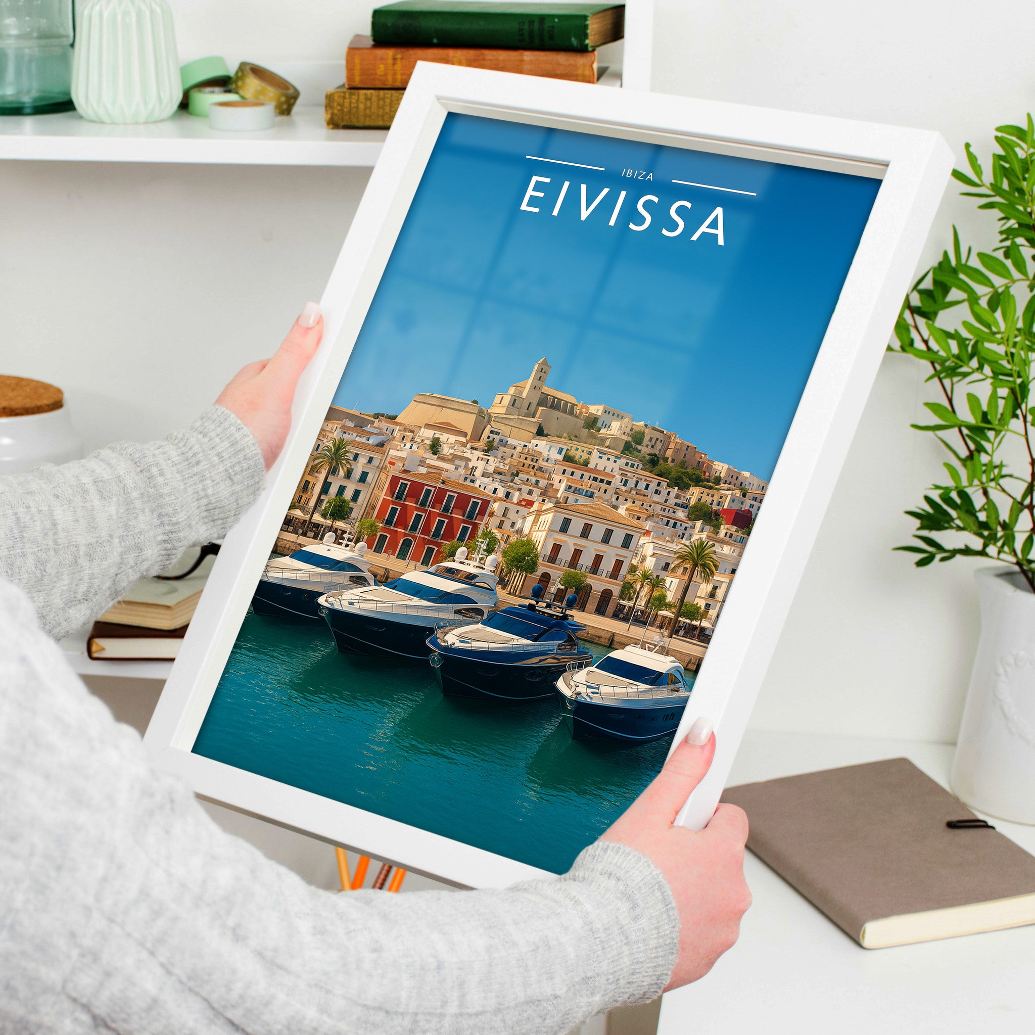 Eivissa Travel Poster in a white frame, held to show scale
