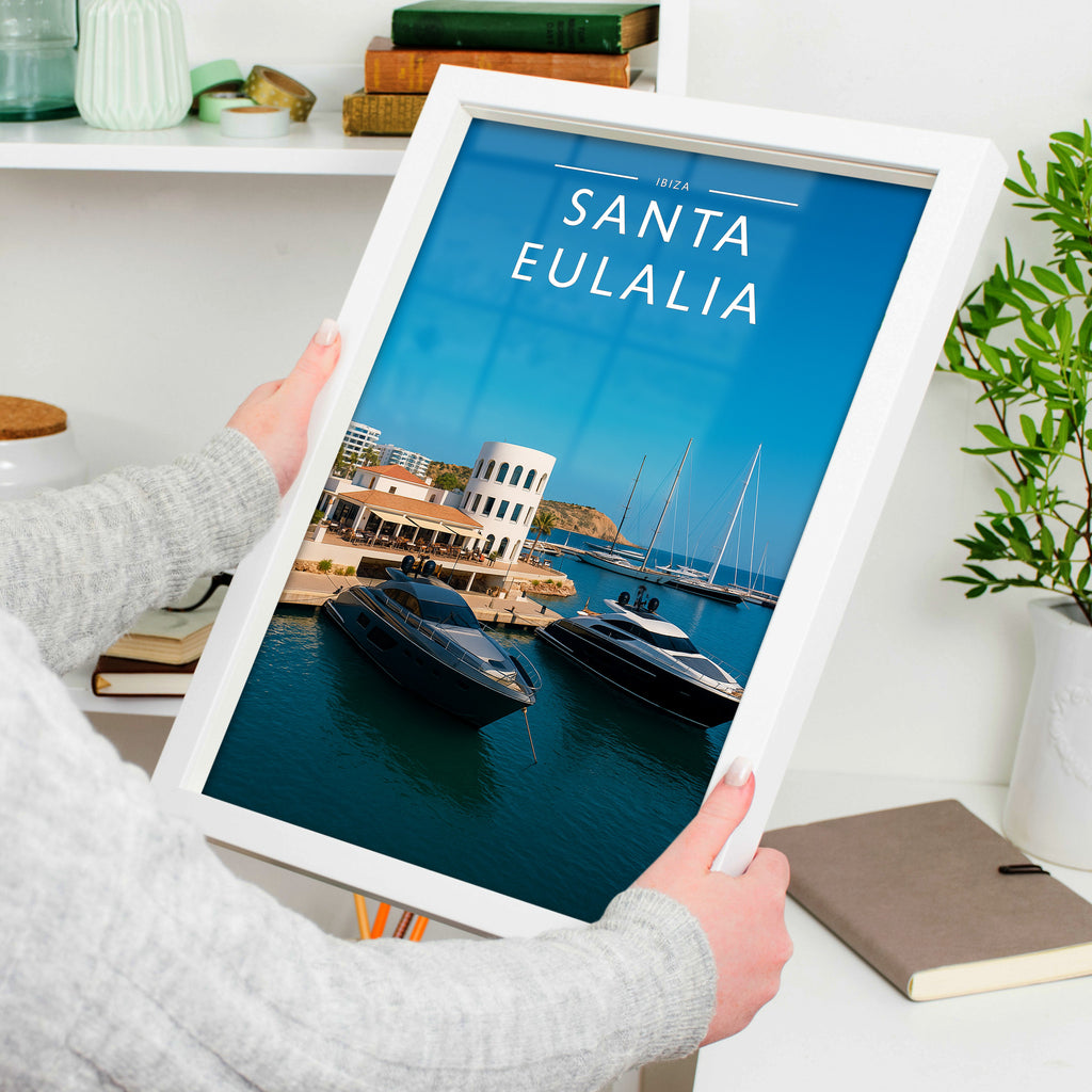 Santa Eulalia Travel Poster in a white frame, held to show scale