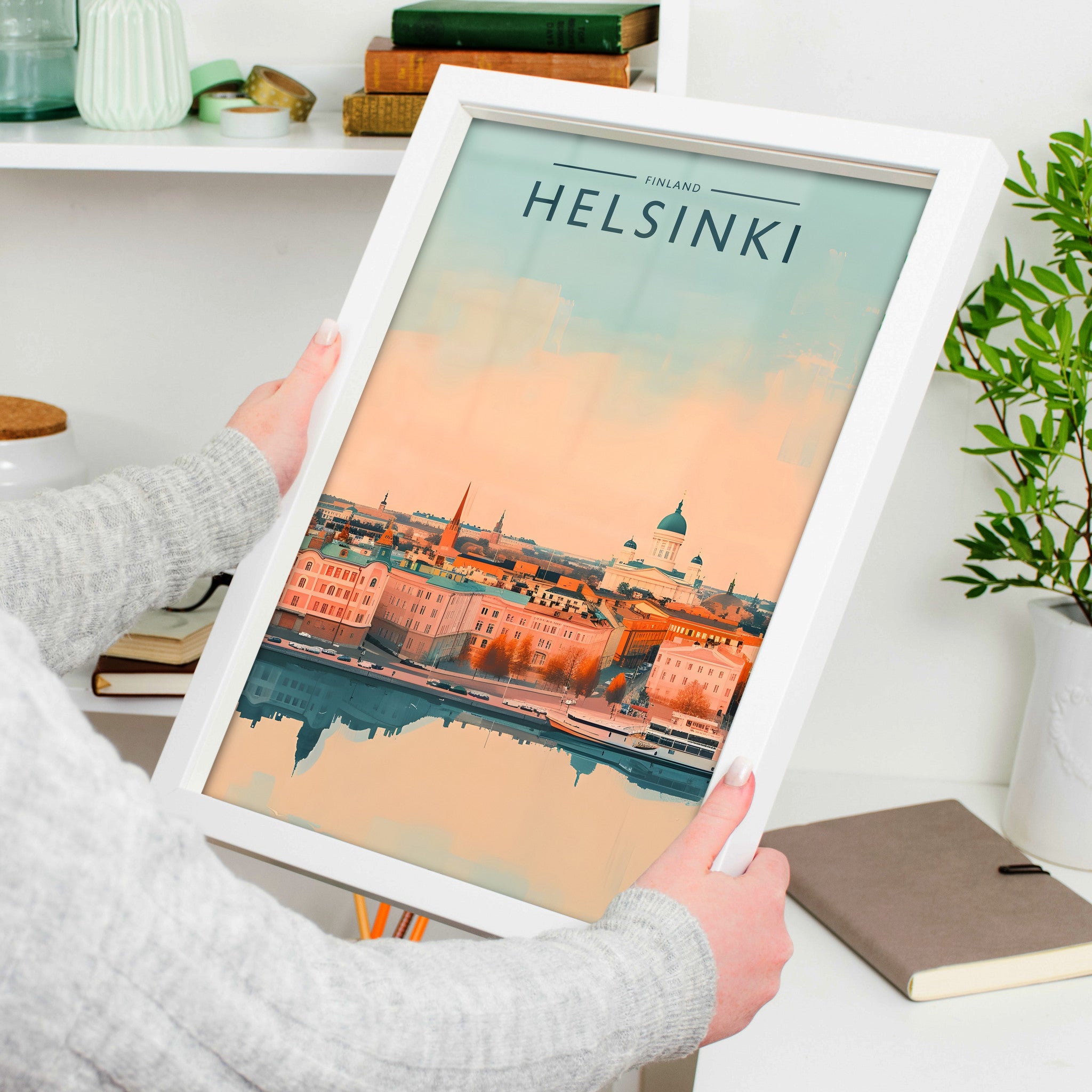 Helsinki Travel Poster in a white frame, held to show scale