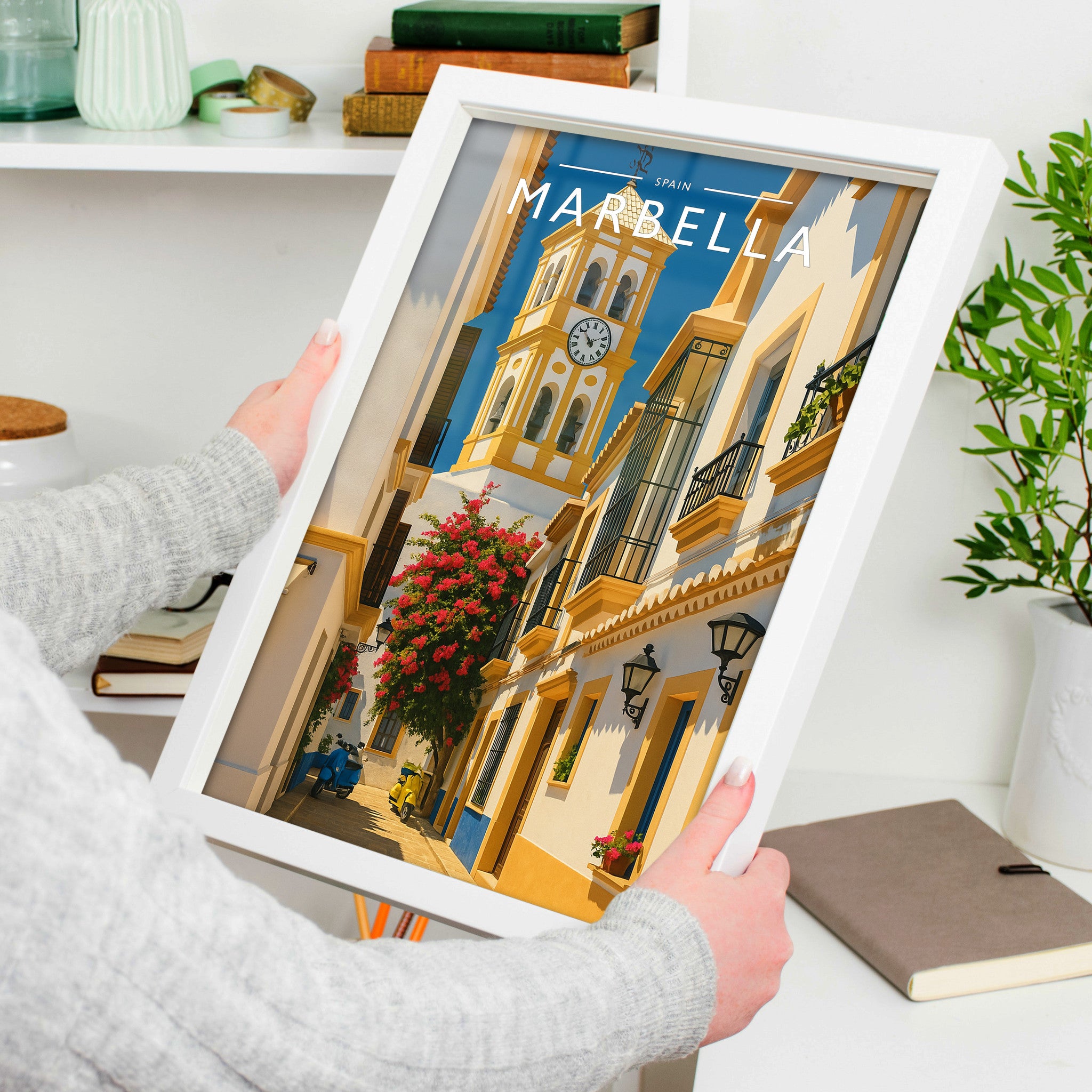Marbella Travel Poster in a white frame, held to show scale