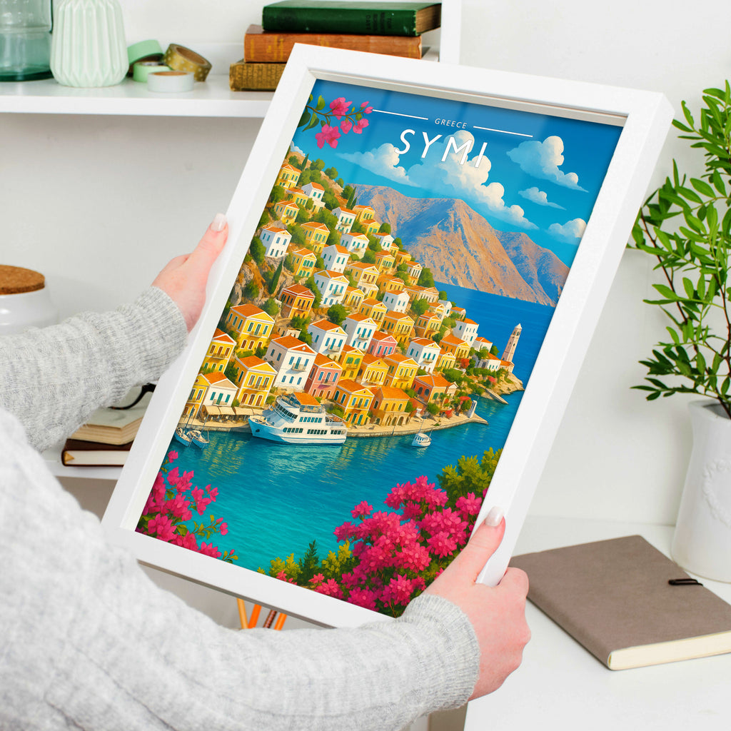 Symi Travel Poster in a white frame, held to show scale