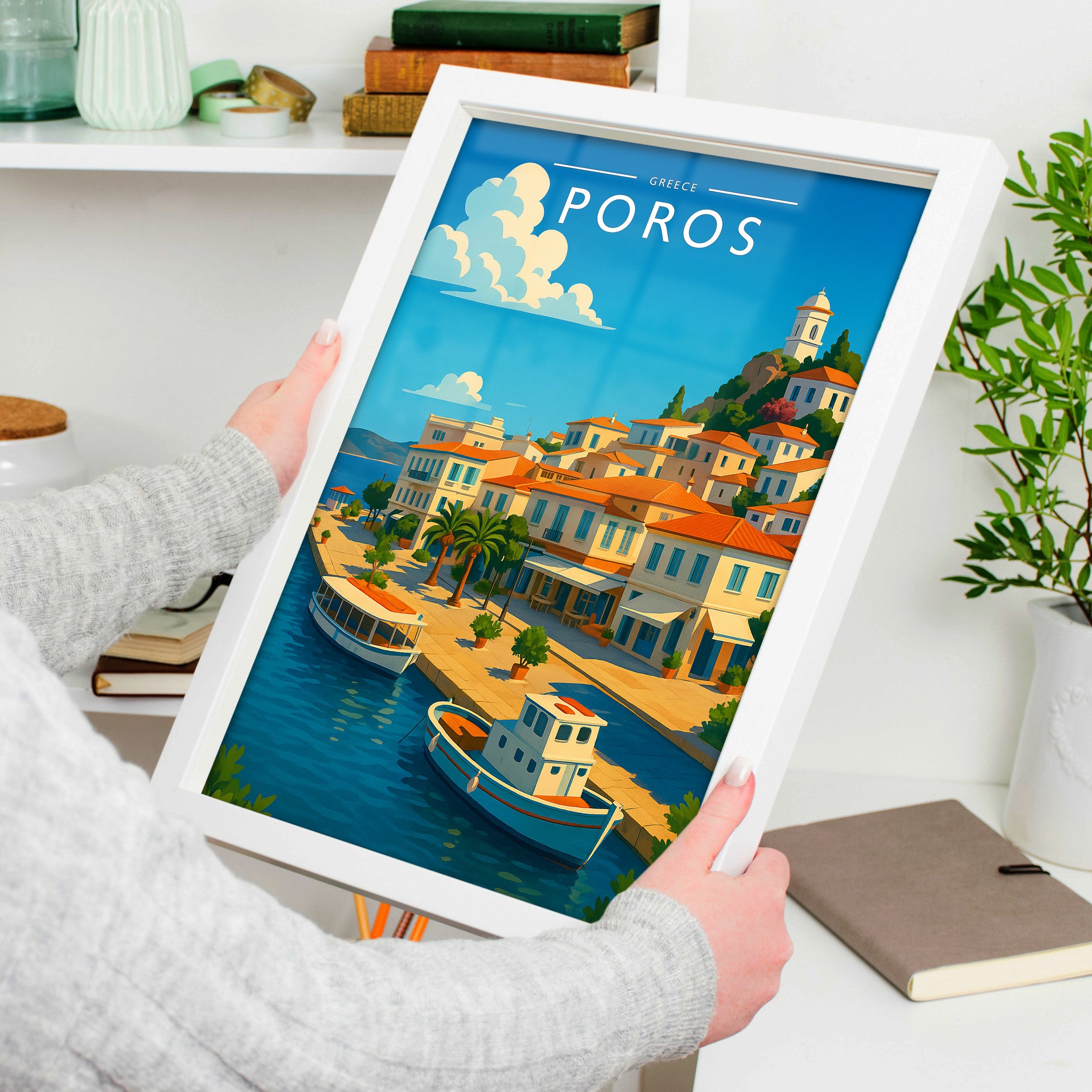 Poros Travel Poster in a white frame, held to show scale