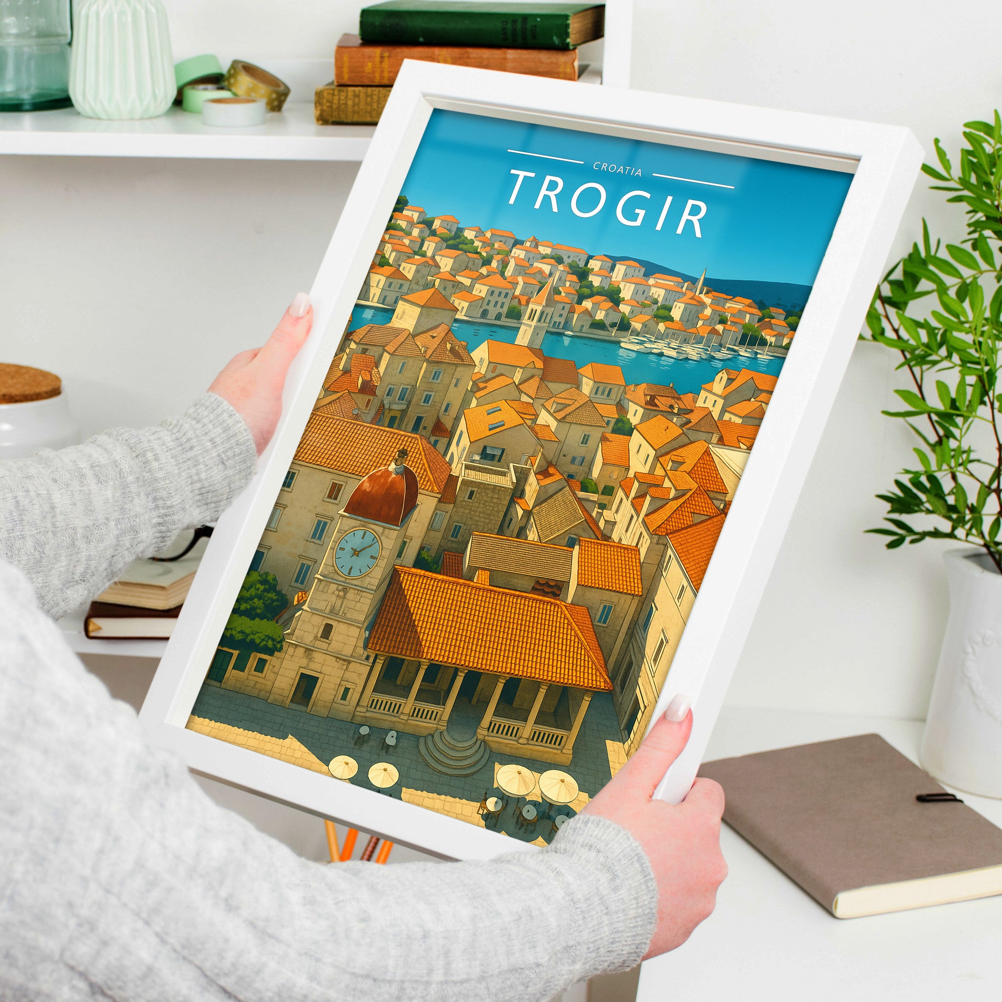 Trogir Travel Poster in a white frame, held to show scale