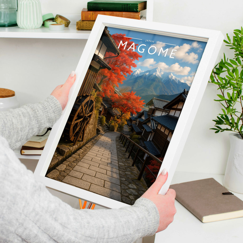 Magome Travel Poster in a white frame, held to show scale