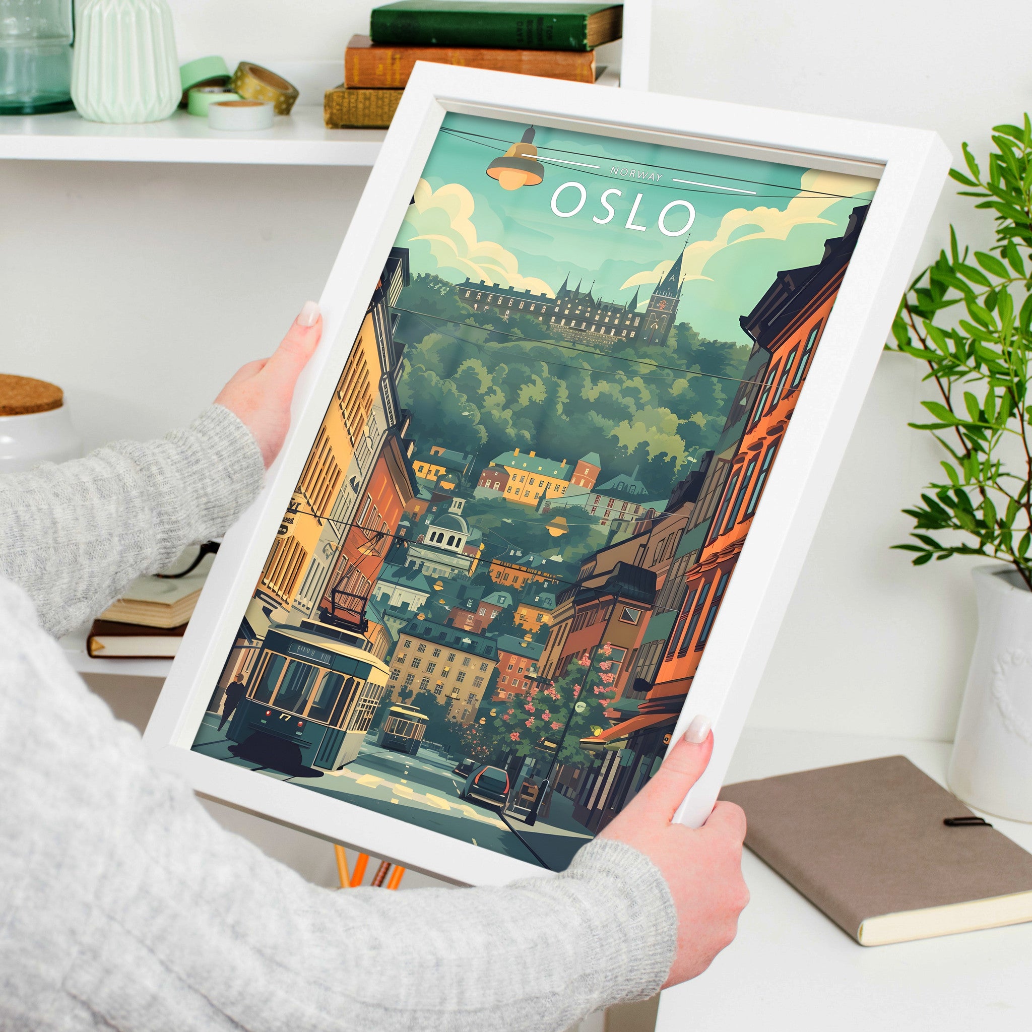 Oslo Travel Poster in a white frame, held to show scale