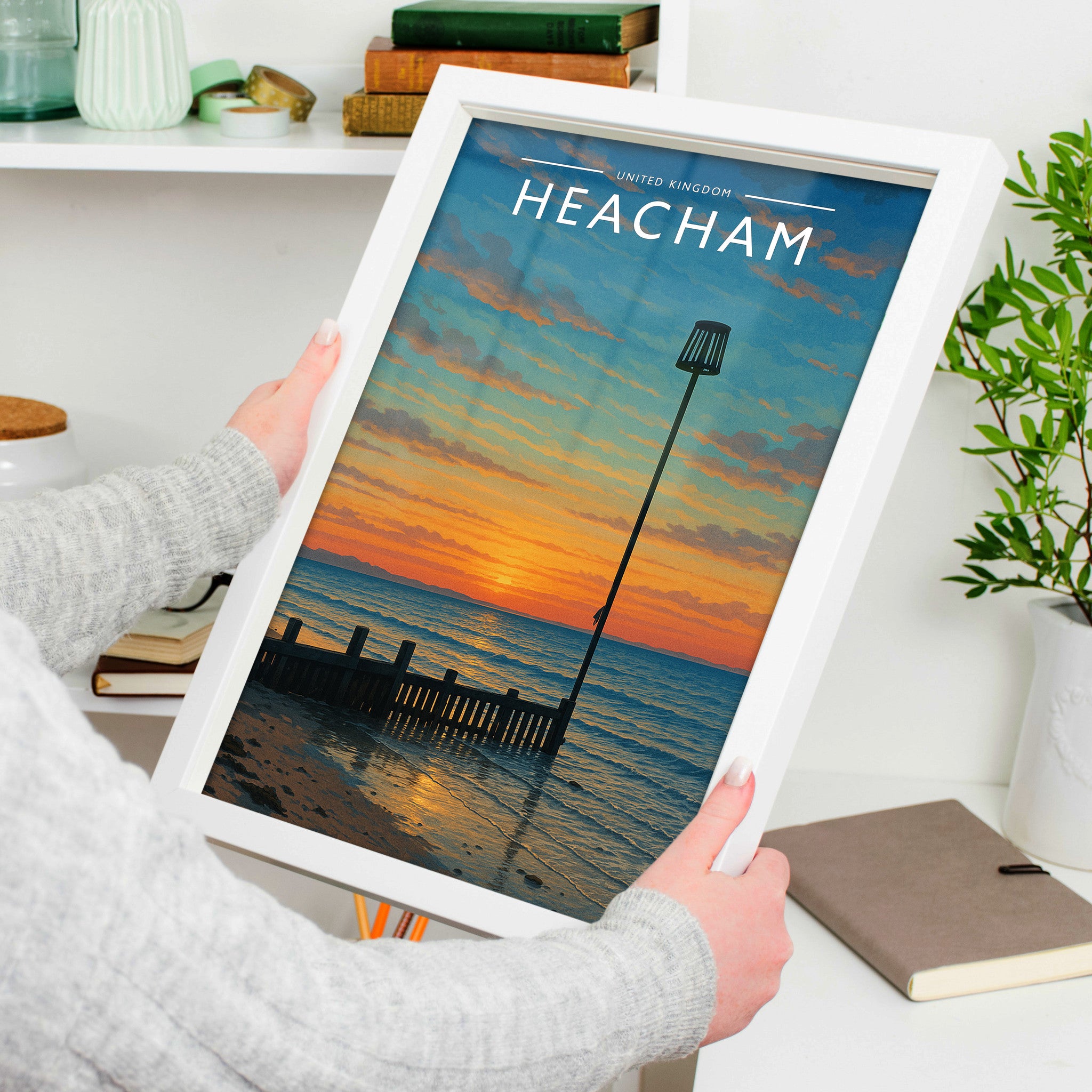 Heacham Travel Poster in a white frame, held to show scale