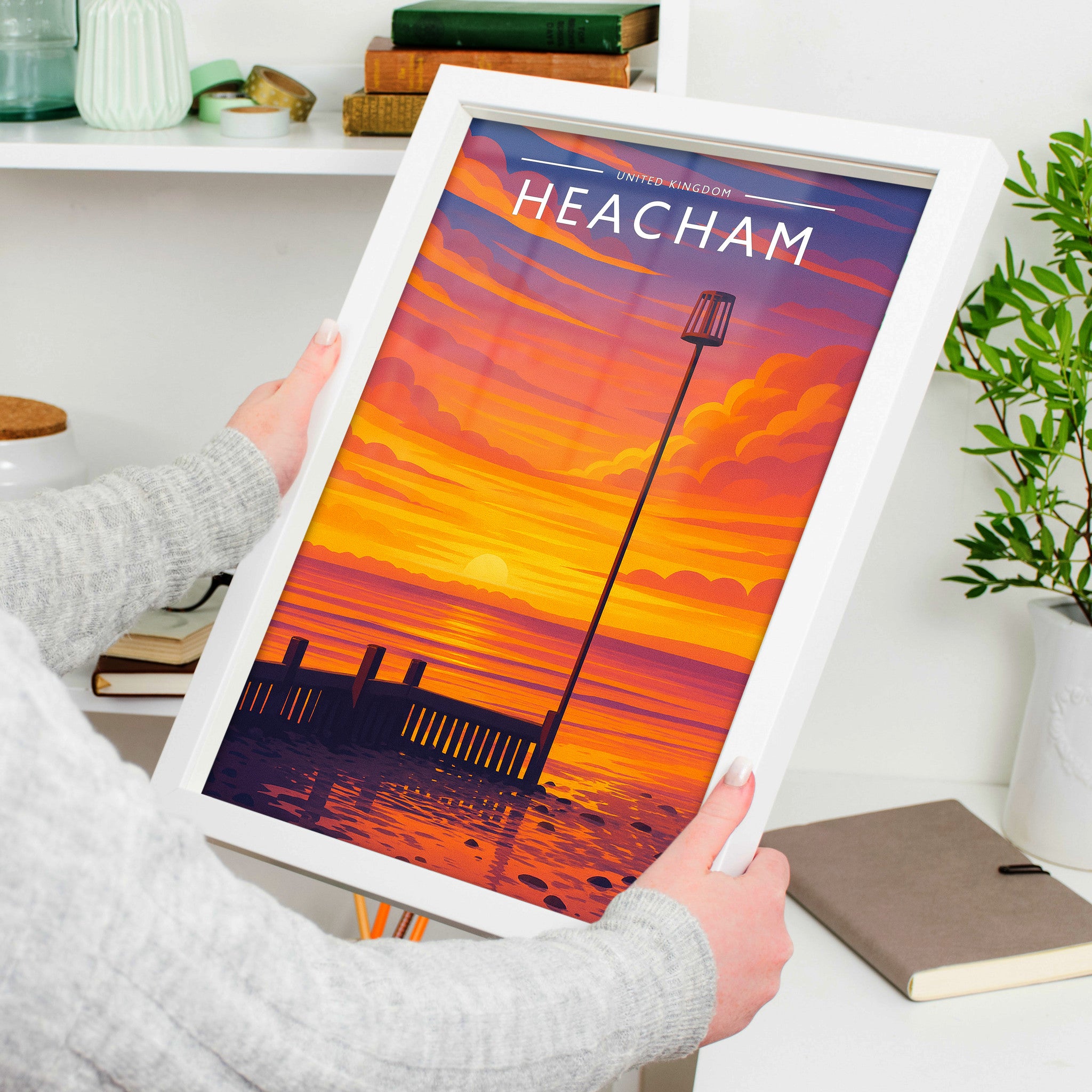 Heacham #2 Travel Poster in a white frame, held to show scale