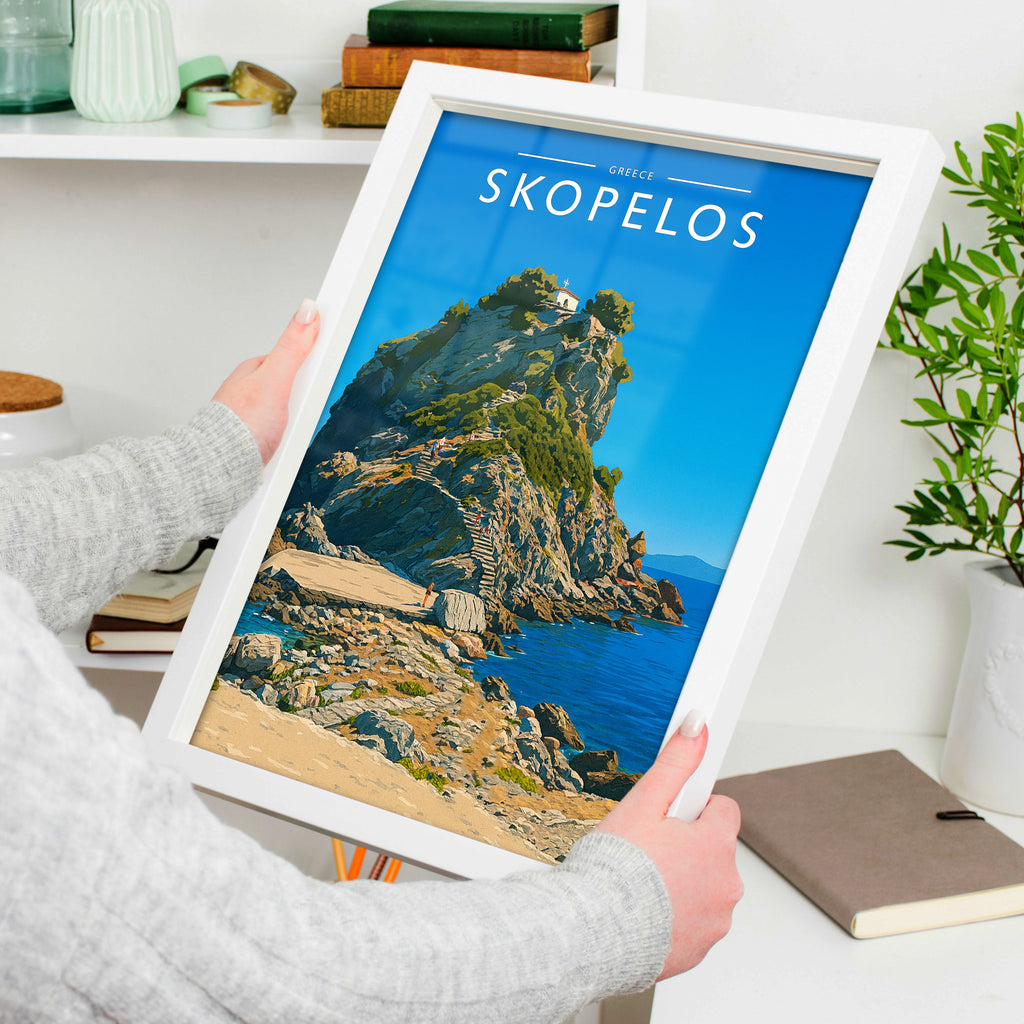 Skopelos Travel Poster in a white frame, held to show scale