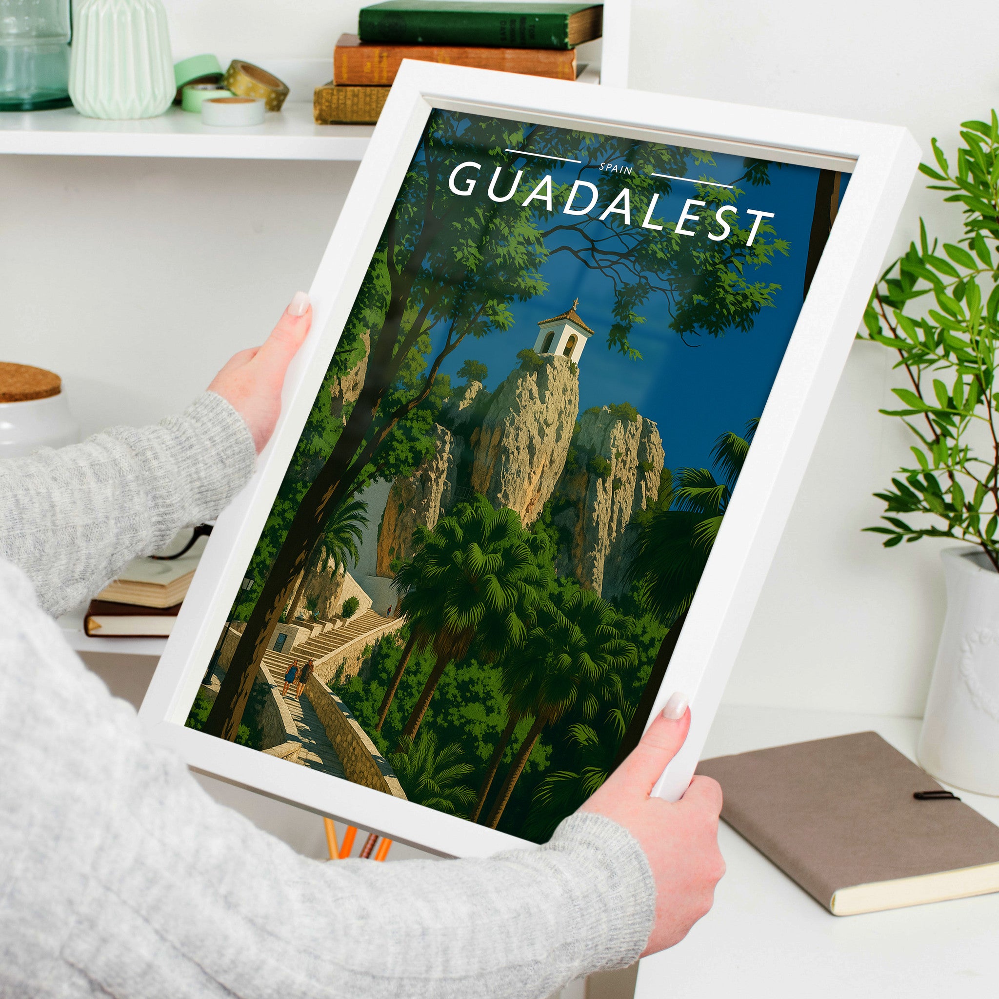 Guadalest Travel Poster in a white frame, held to show scale