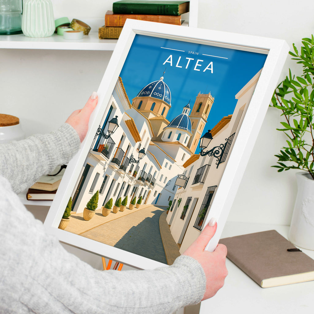 Altea Travel Poster in a white frame, held to show scale