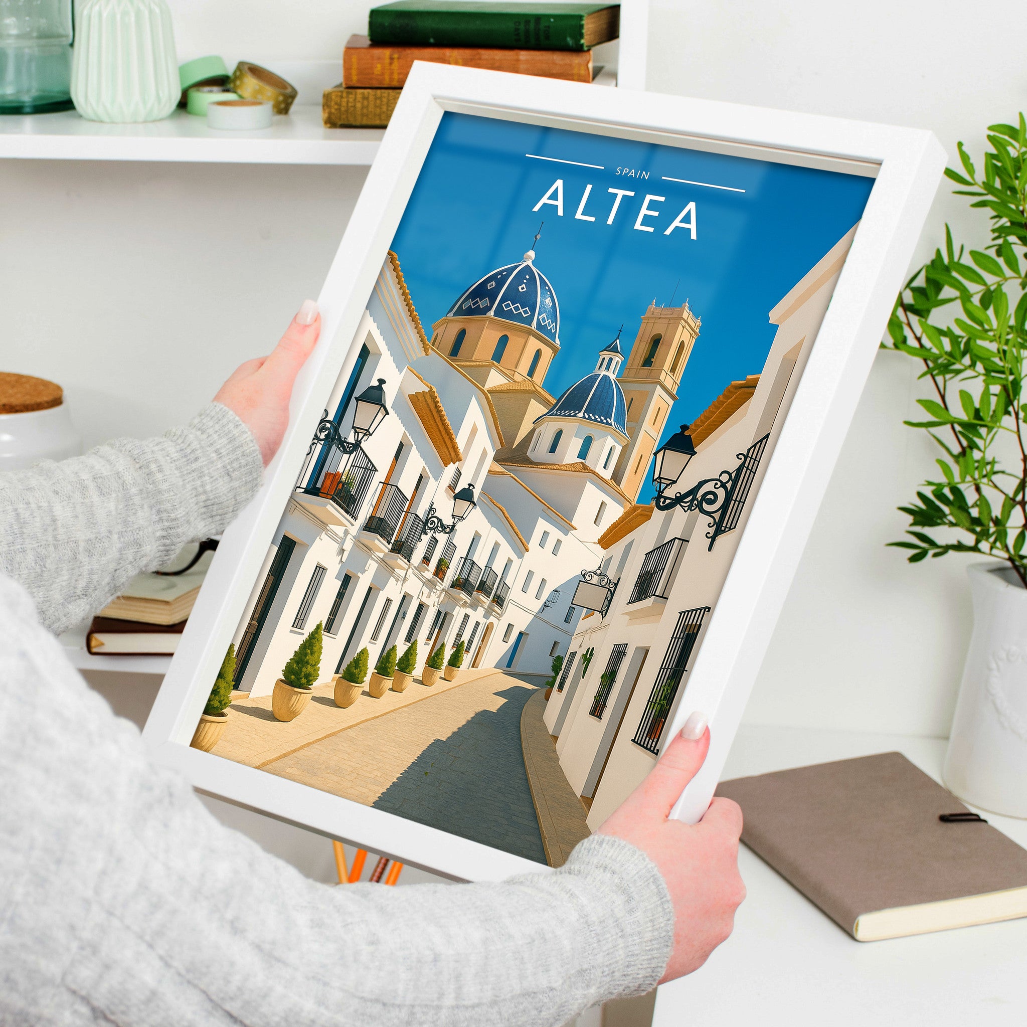 Altea Travel Poster in a white frame, held to show scale