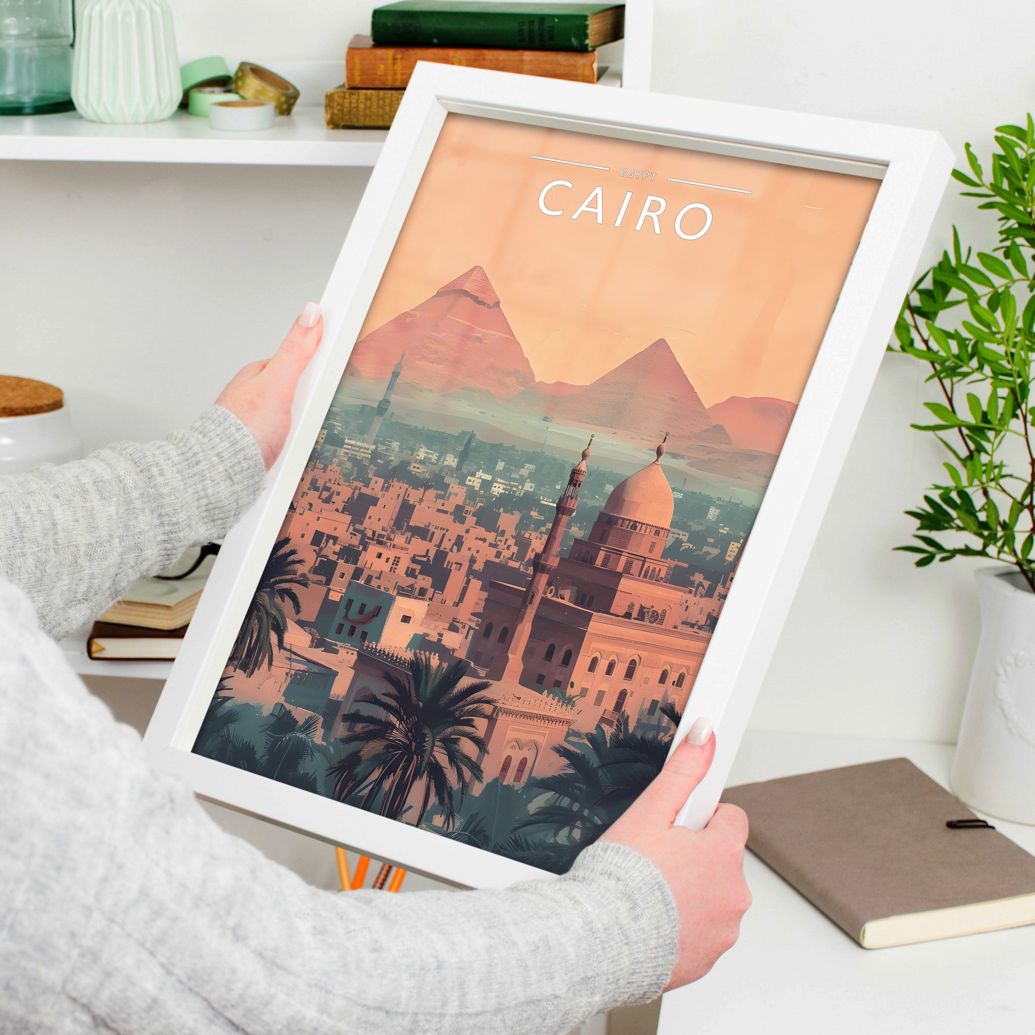Cairo Travel Poster in a white frame, held to show scale