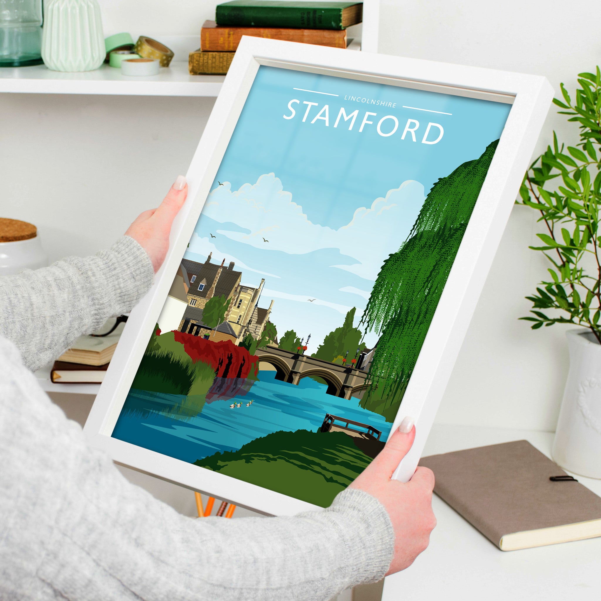 Stamford Travel Poster in a white frame, held to show scale