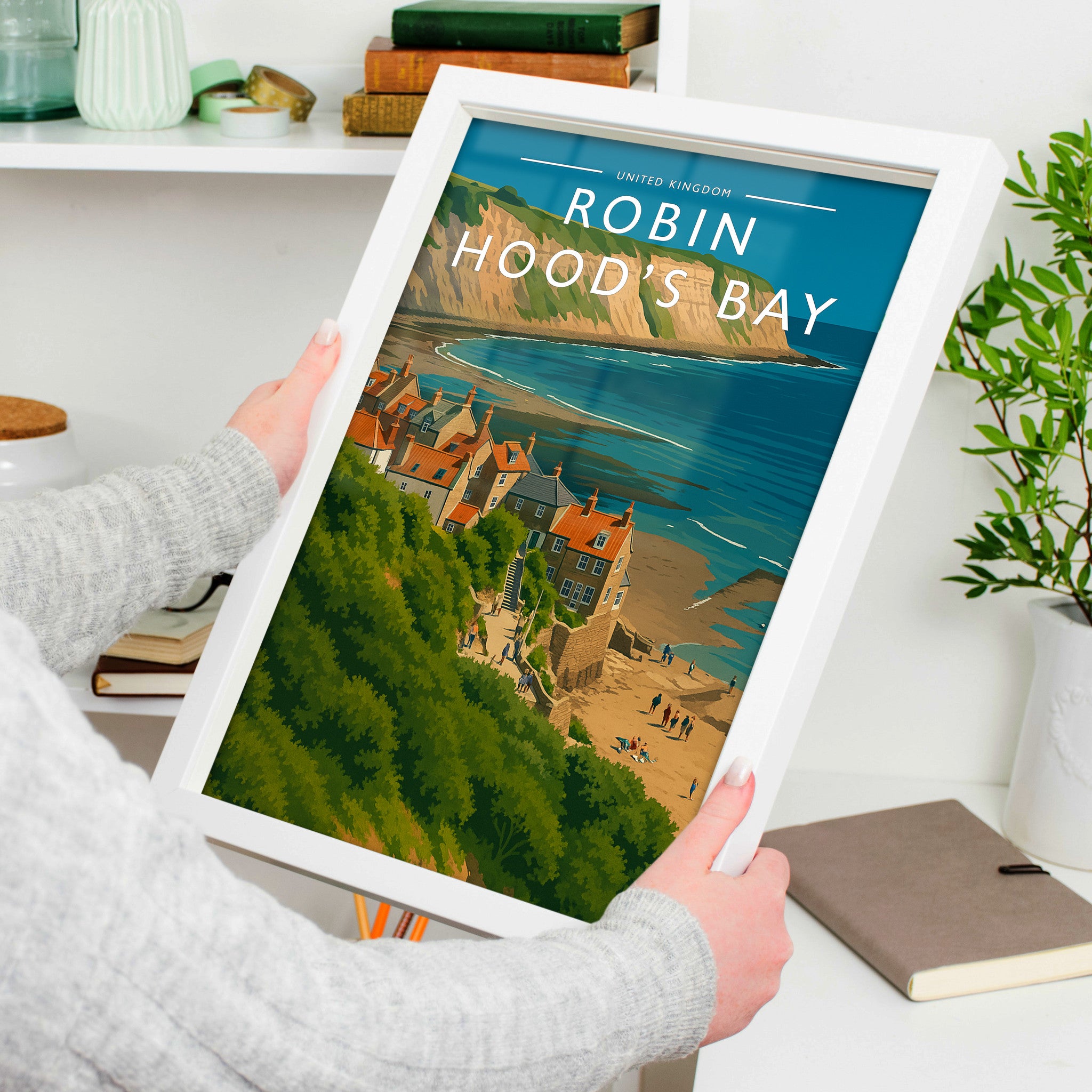 Robin Hood’s Bay Travel Poster in a white frame, held to show scale