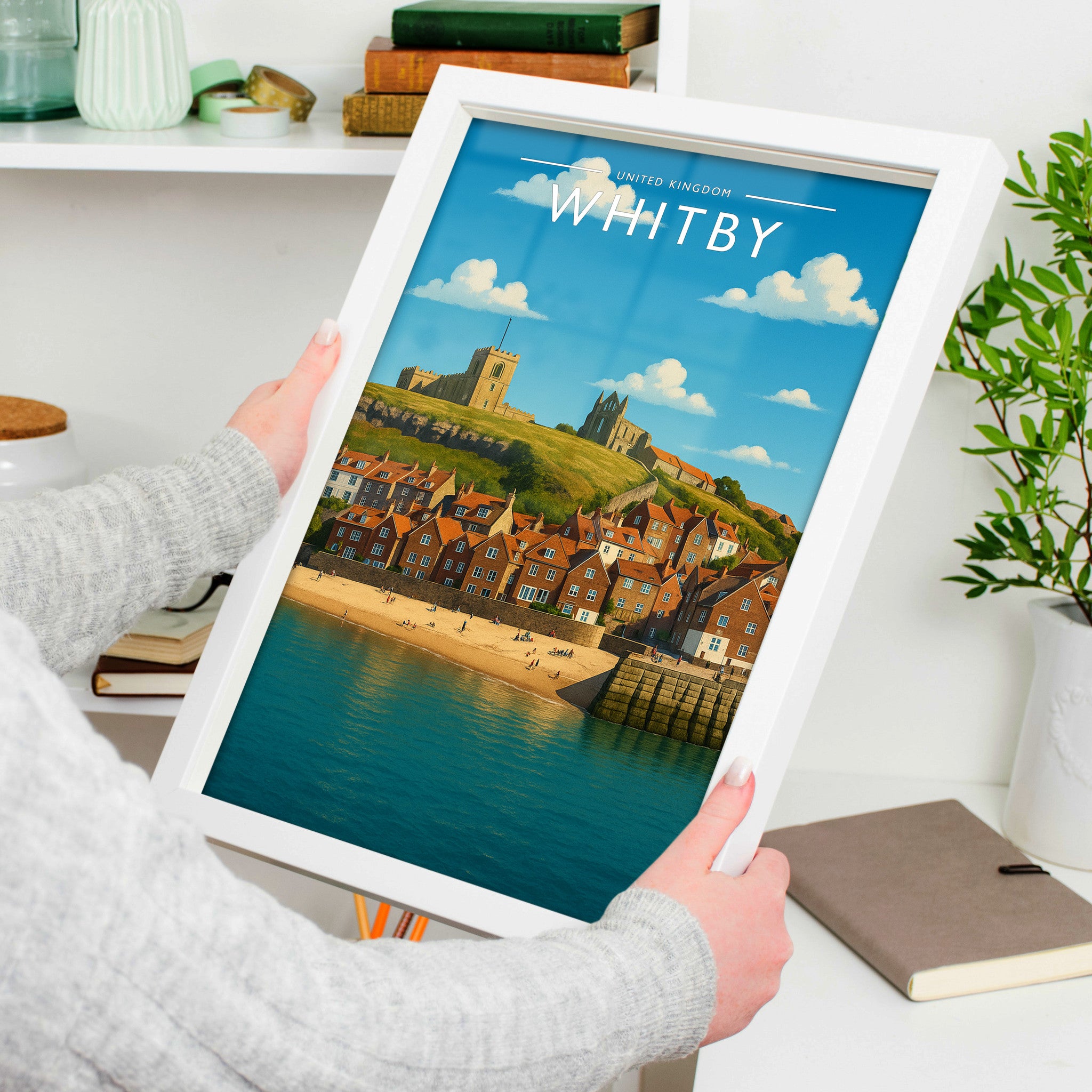 Whitby #2 Travel Poster in a white frame, held to show scale