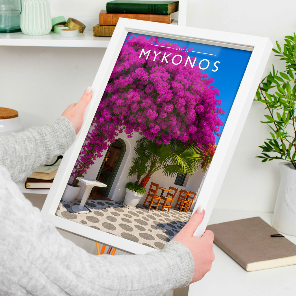 Mykonos Travel Poster in a white frame, held to show scale