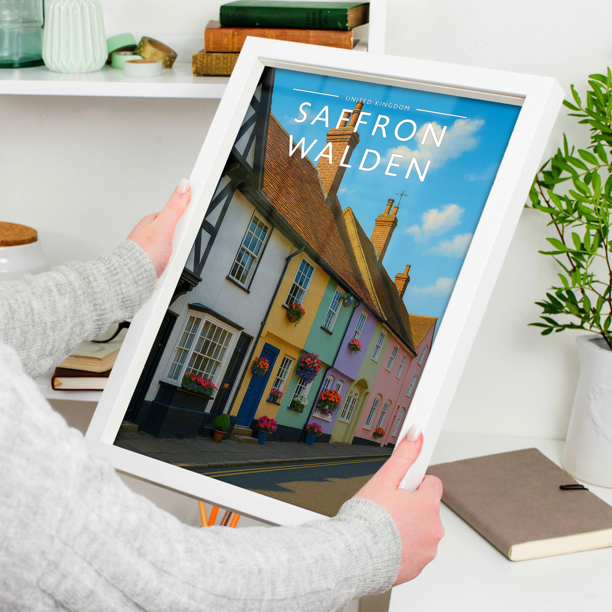 Saffron Walden Travel Poster in a white frame, held to show scale