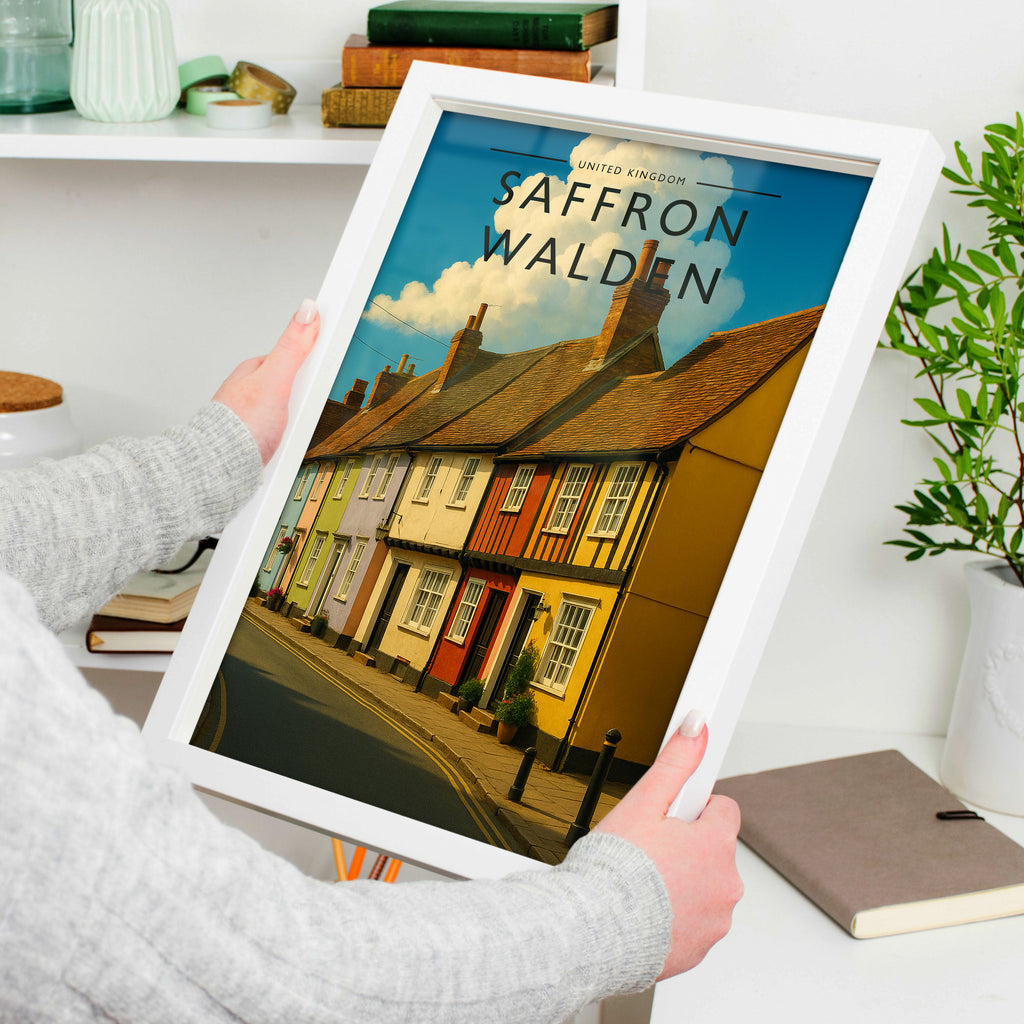 Saffron Walden #2 Travel Poster in a white frame, held to show scale
