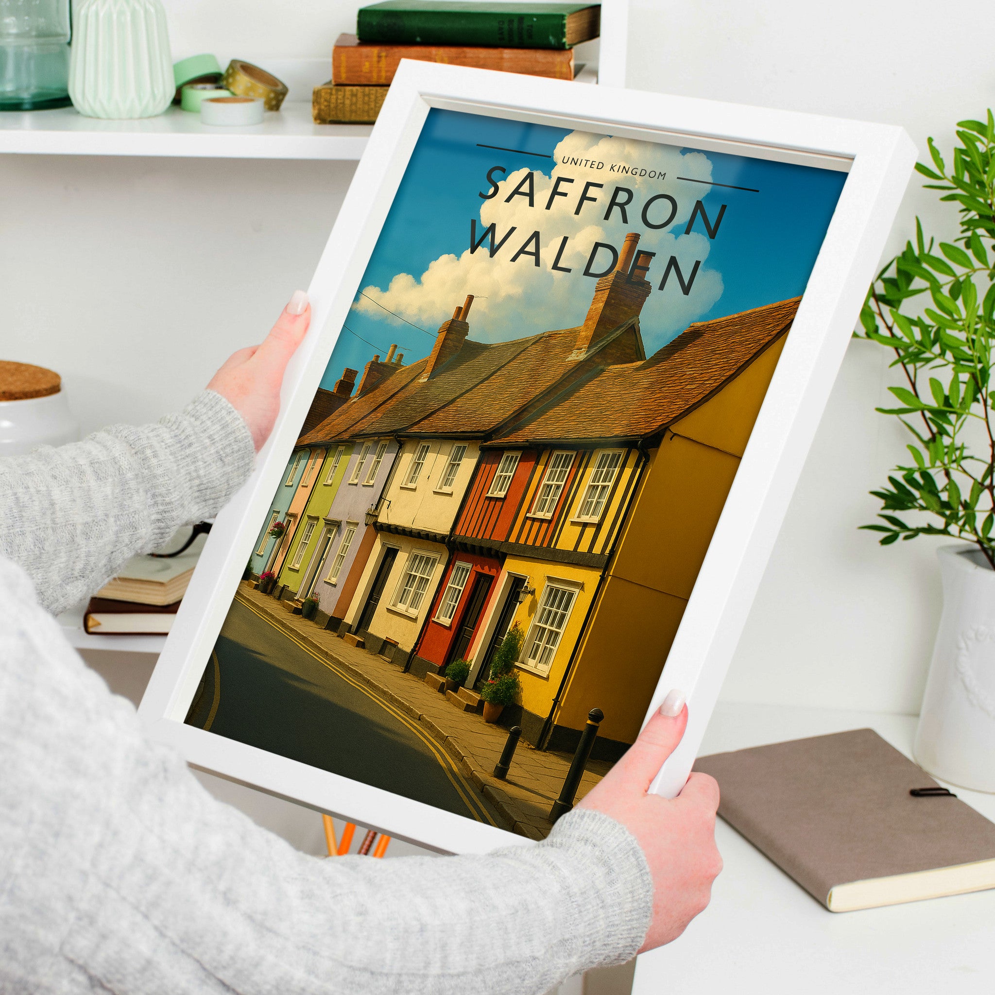 Saffron Walden #2 Travel Poster in a white frame, held to show scale