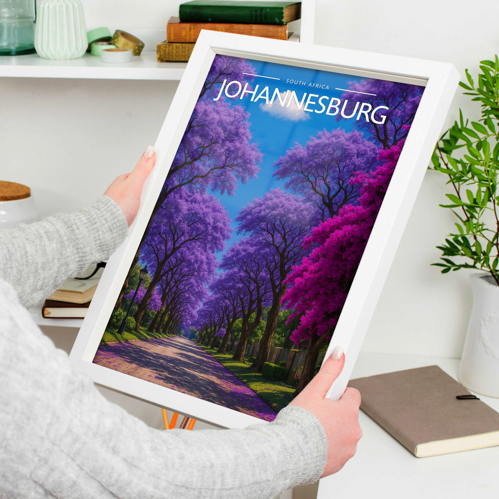 Johannesburg Travel Poster in a white frame, held to show scale