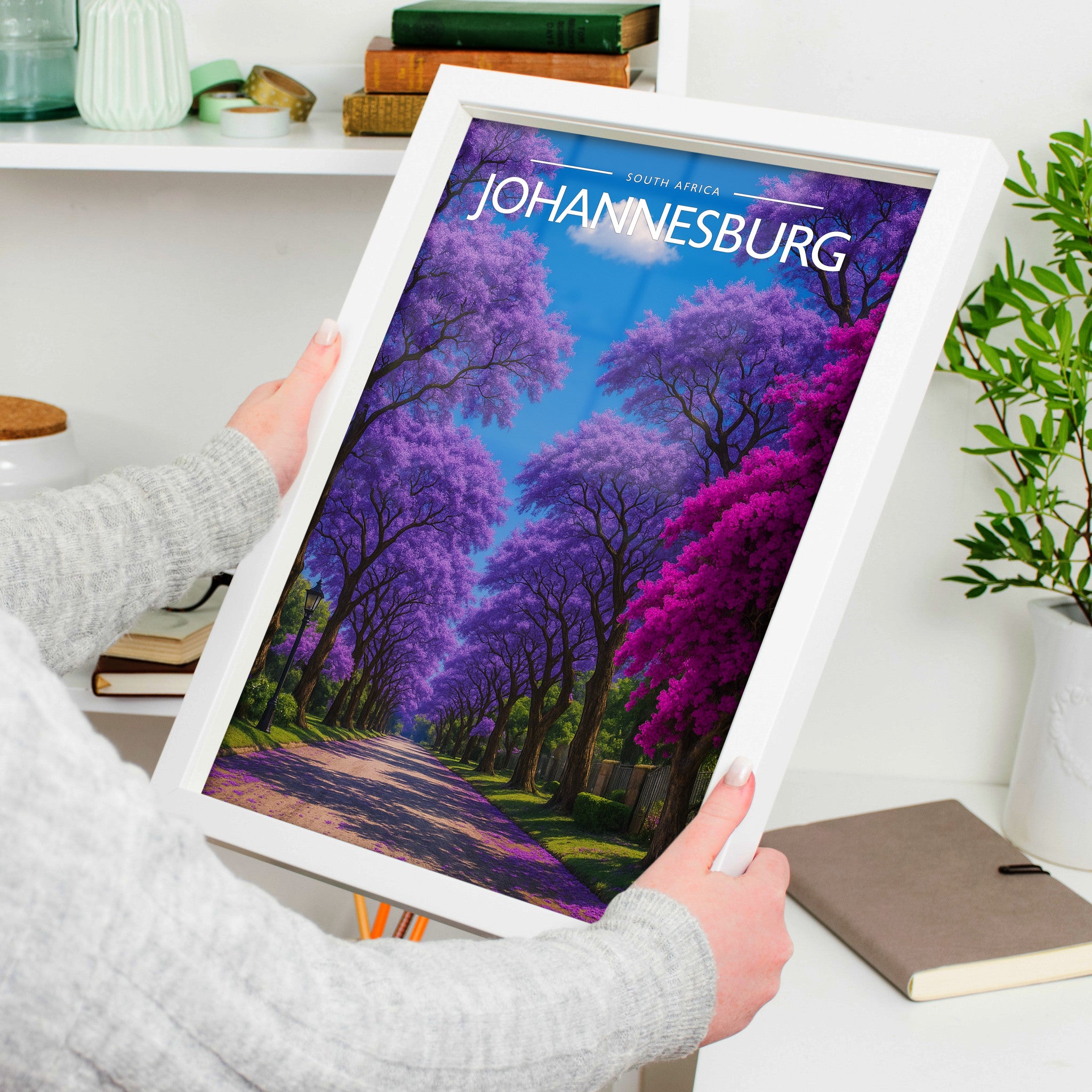 Johannesburg Travel Poster in a white frame, held to show scale