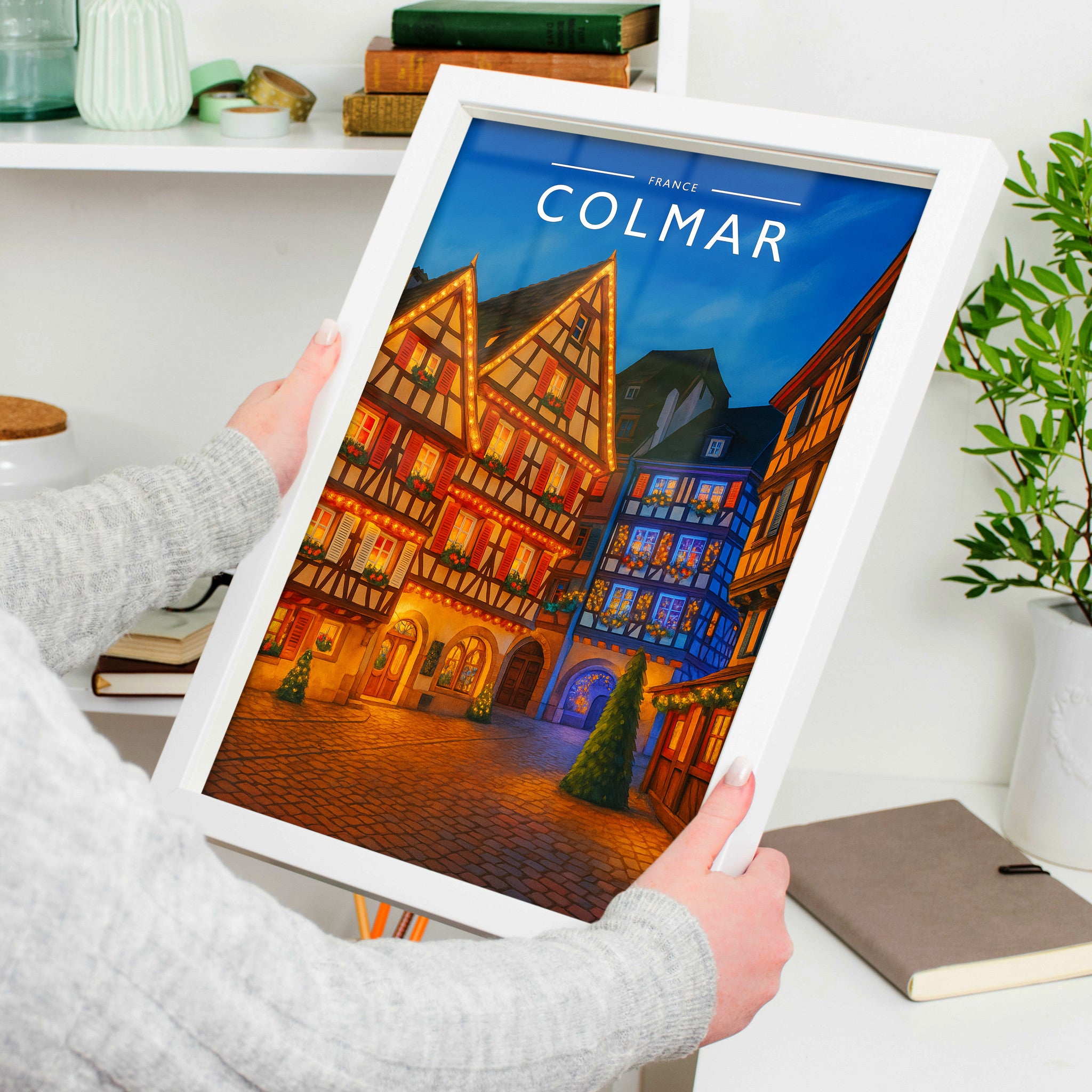 Colmar Travel Poster in a white frame, held to show scale