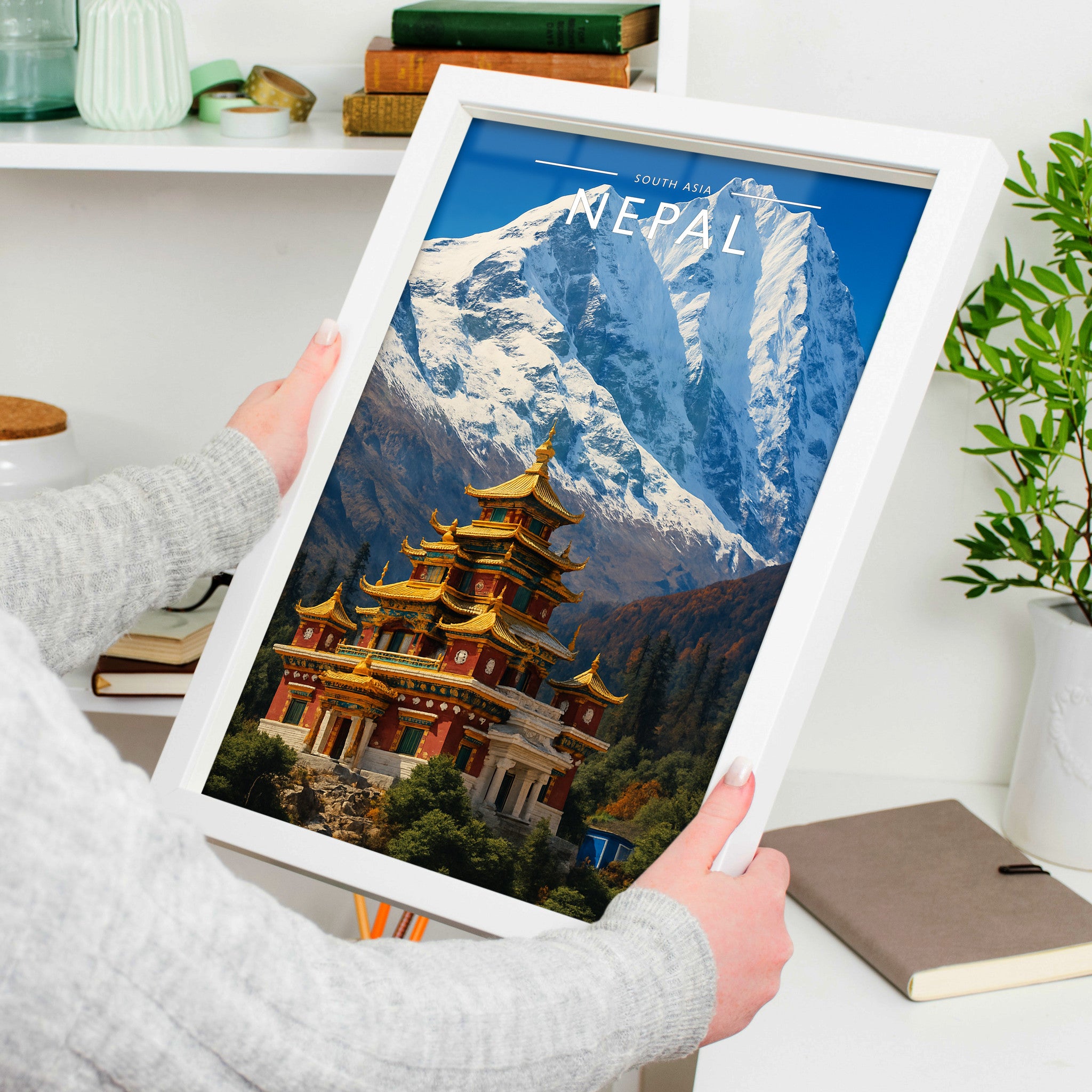 Nepal Travel Poster in a white frame, held to show scale