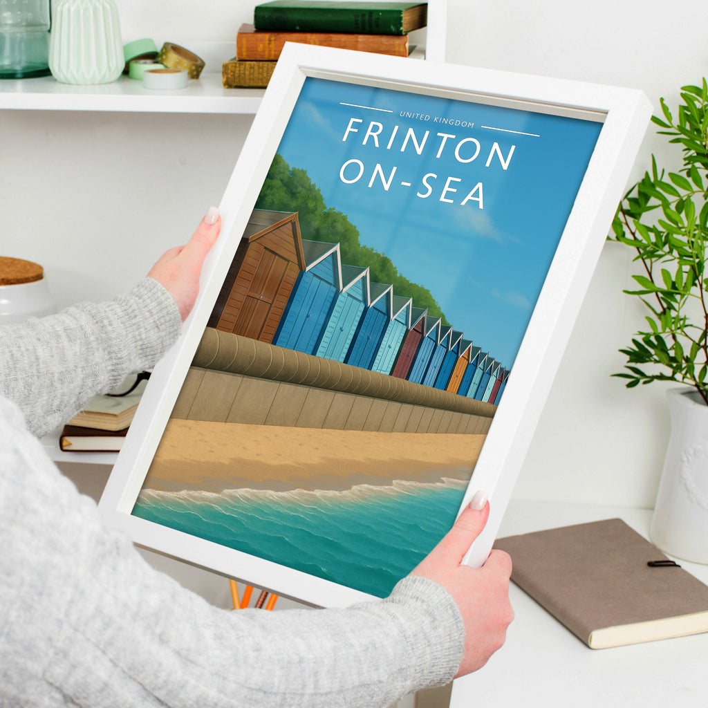 Frinton-on-Sea Travel Poster in a white frame, held to show scale