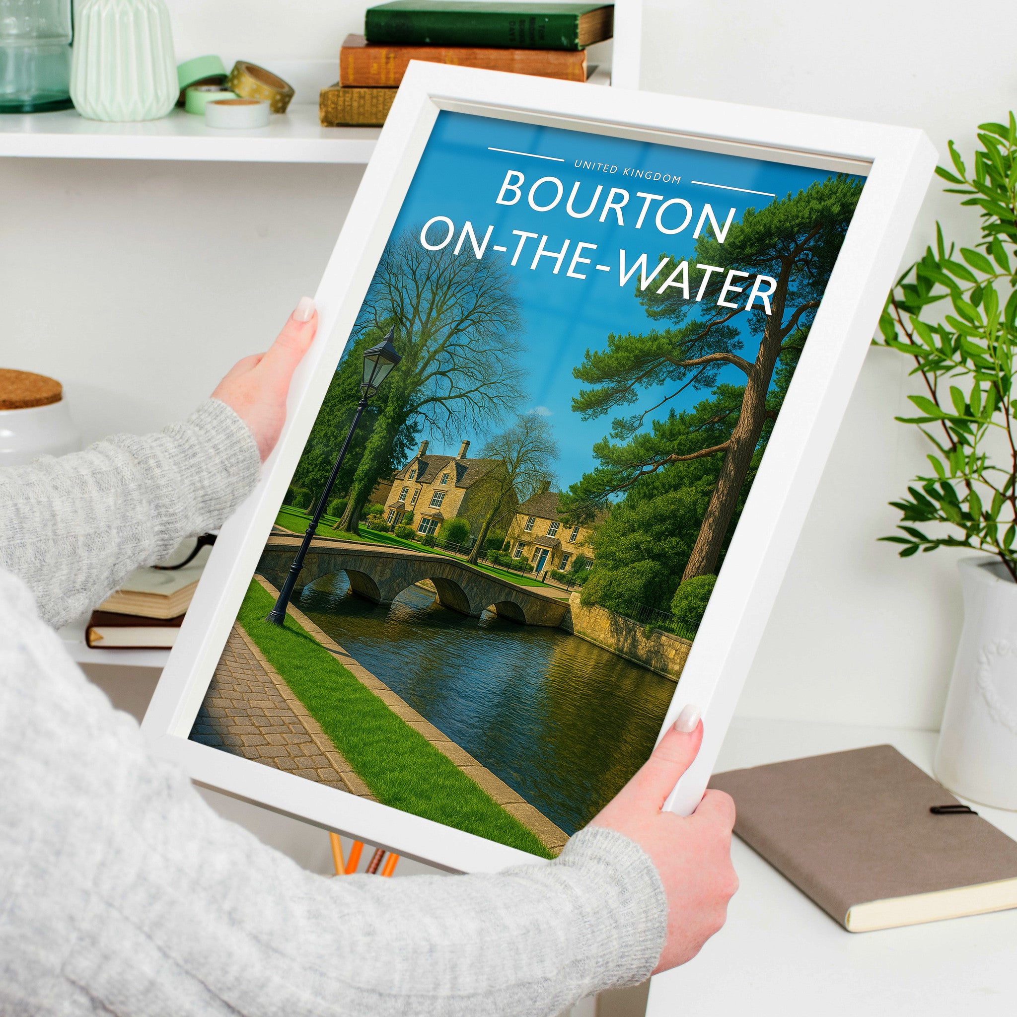 Bourton-on-the-Water Travel Poster in a white frame, held to show scale