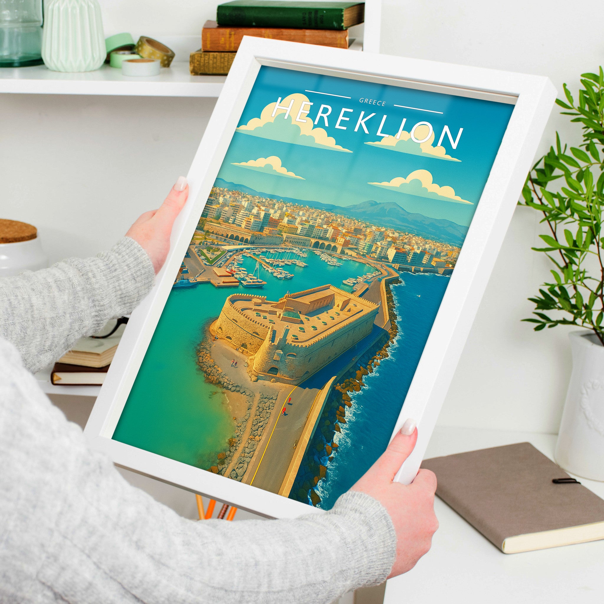 Heraklion Travel Poster in a white frame, held to show scale