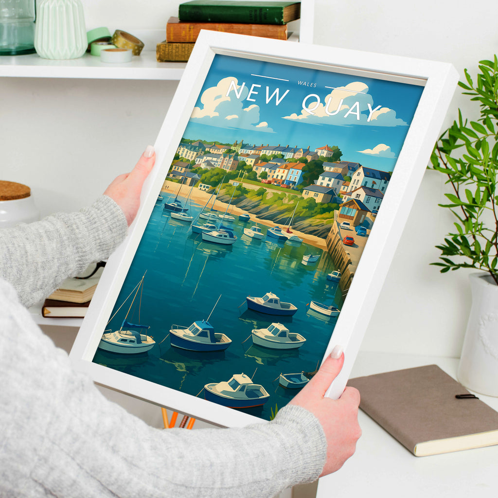 New Quay Travel Poster in a white frame, held to show scale