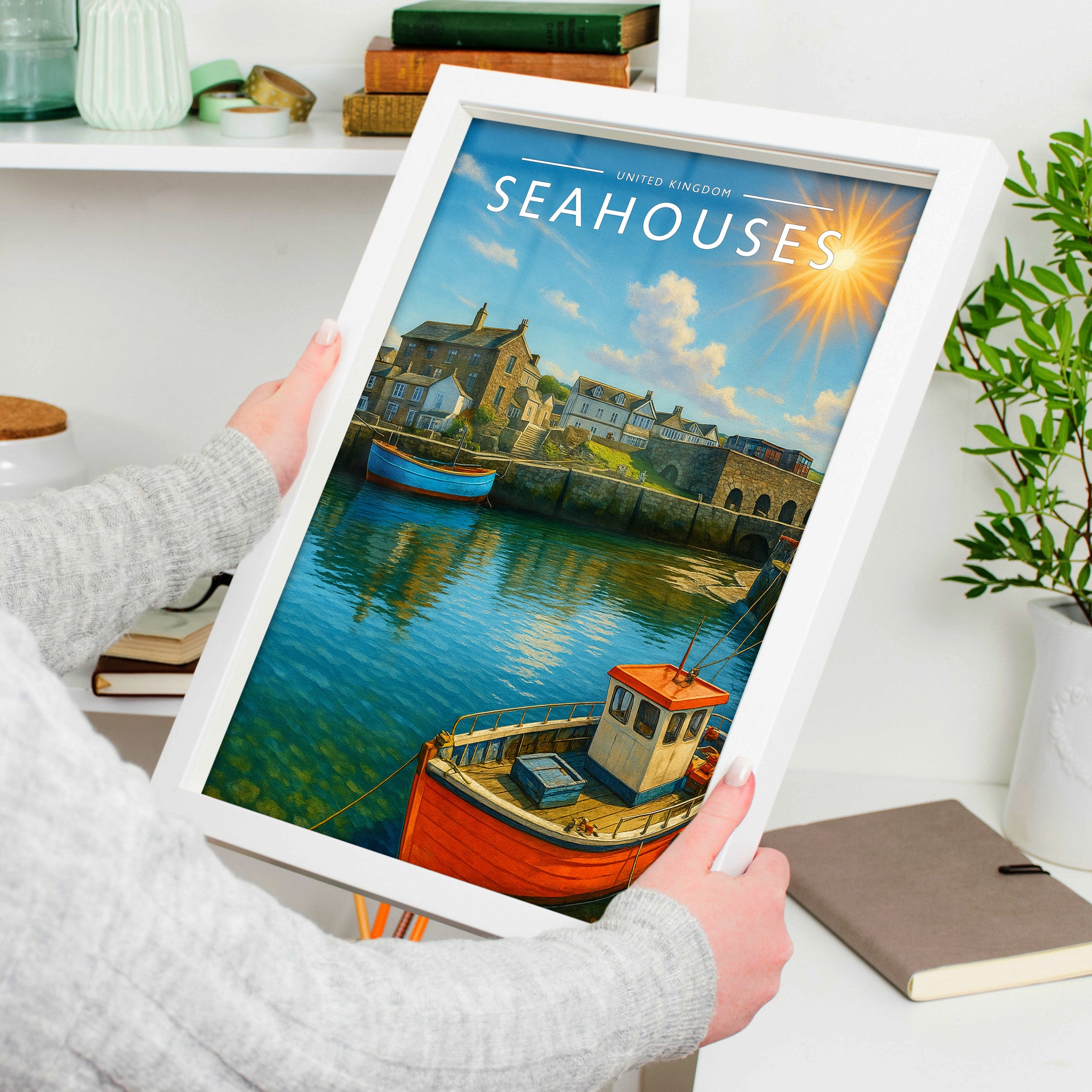 Seahouses Travel Poster in a white frame, held to show scale