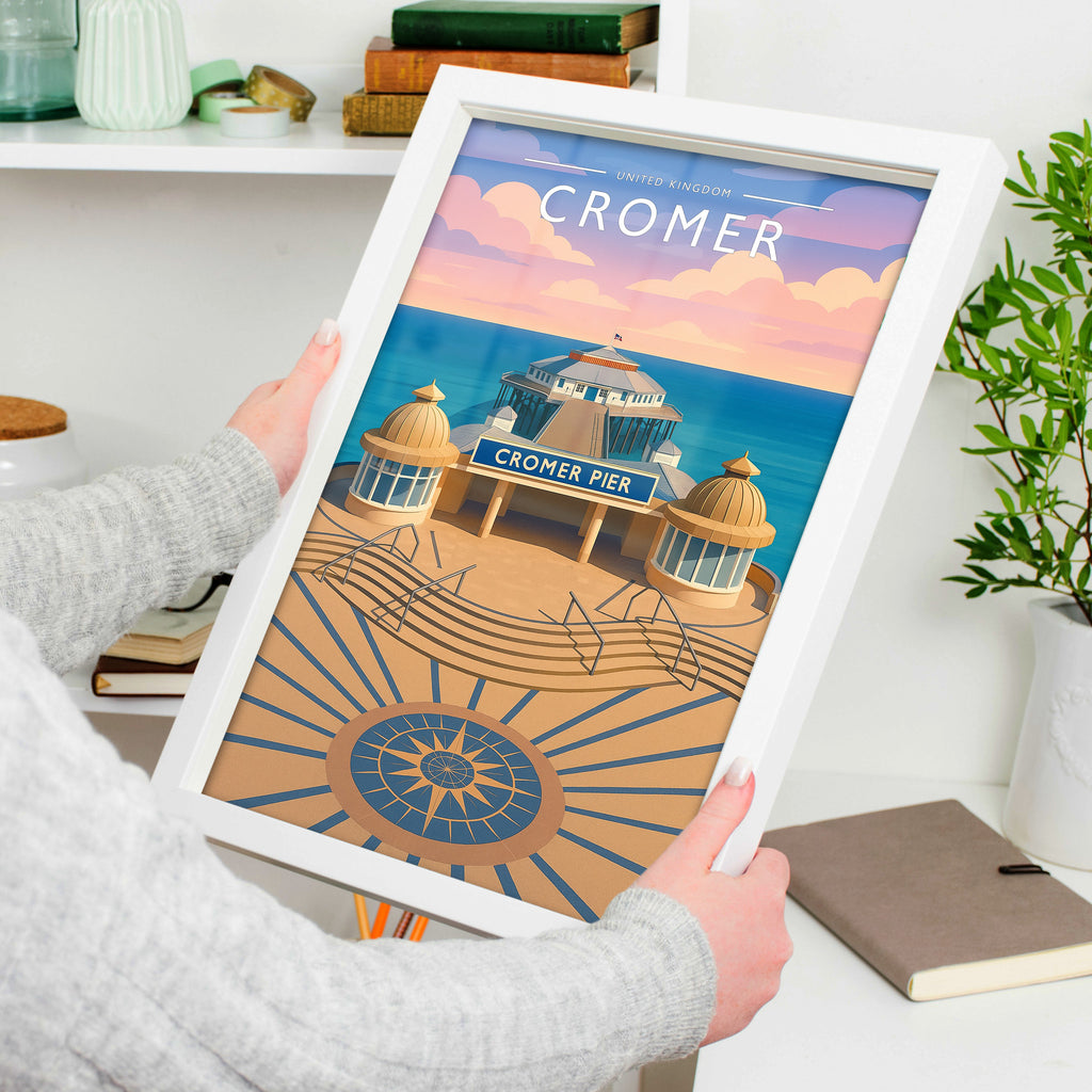 Cromer Travel Poster in a white frame, held to show scale