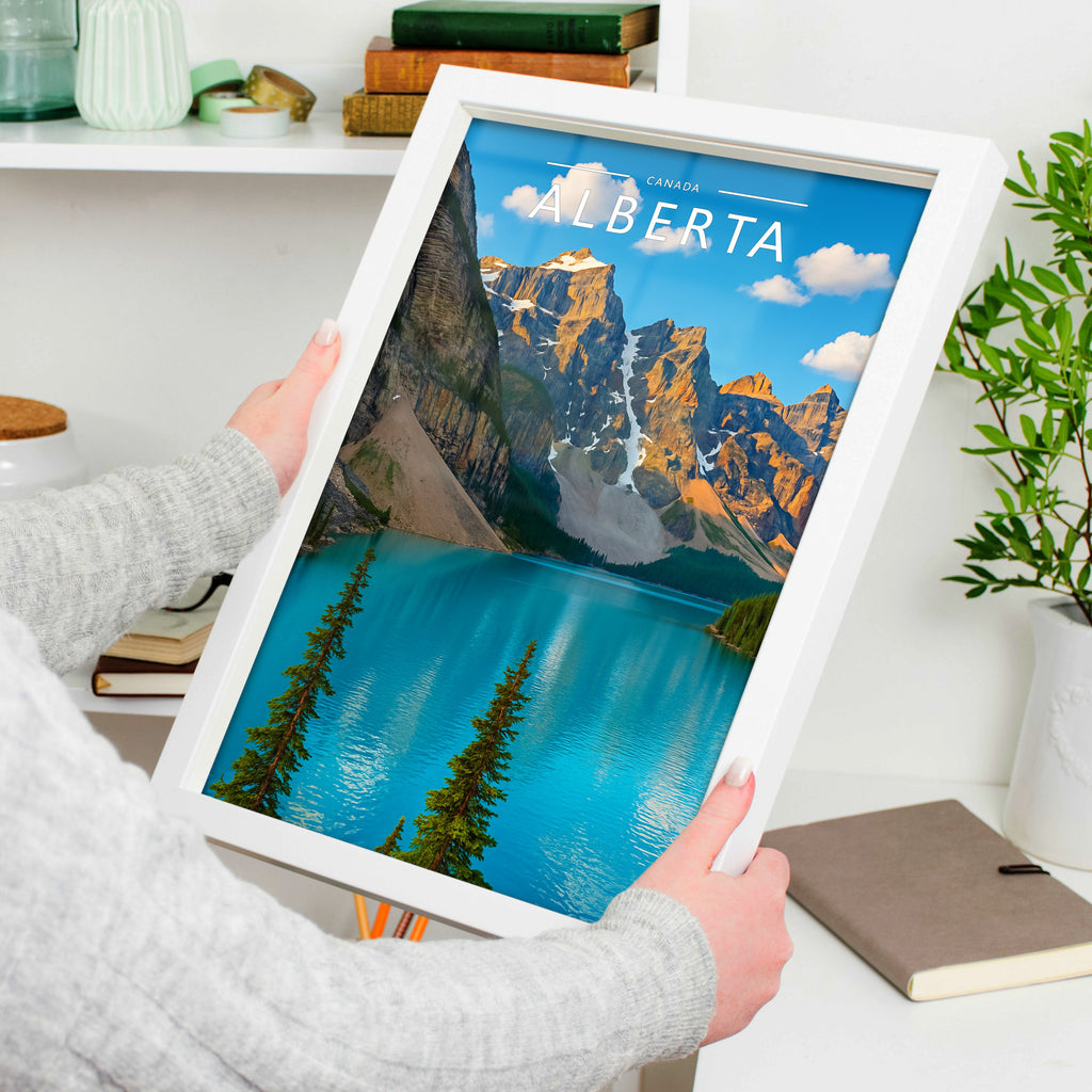 Alberta Travel Poster in a white frame, held to show scale