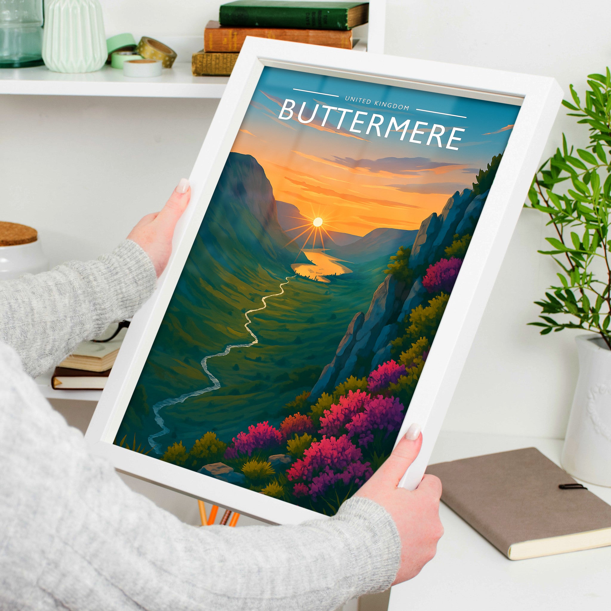 Buttermere Travel Poster in a white frame, held to show scale
